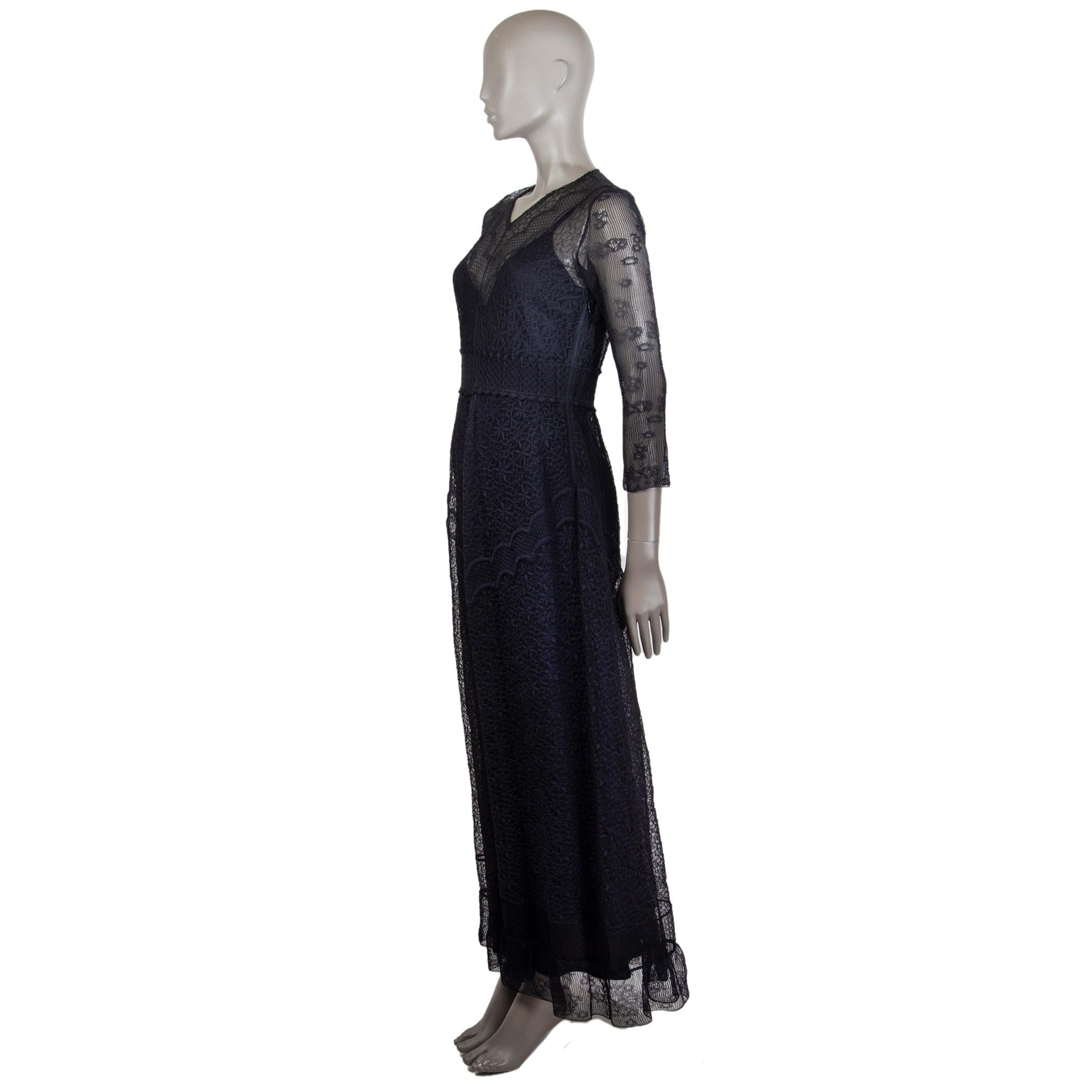 Christian Dior sheer flared lace dress in marine blue polyester (assumed as tag is missing) with a v-neck. Comes with a slip dress in marine blue silk (assumed as tag is missing). Closes on the side with a concealed zipper and fastens on the back