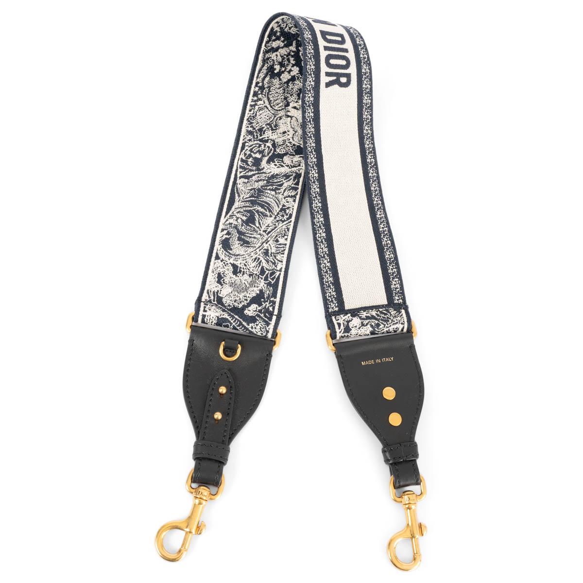 100% authentic Christian Dior shoulder-strap in navy blue Toile de Jouy Sauvage embroidery with black calfskin and gold-tone hardware. the design features on the other side Christian Dior Paris signature. Can be attached to Lady Dior, Saddle, Dior