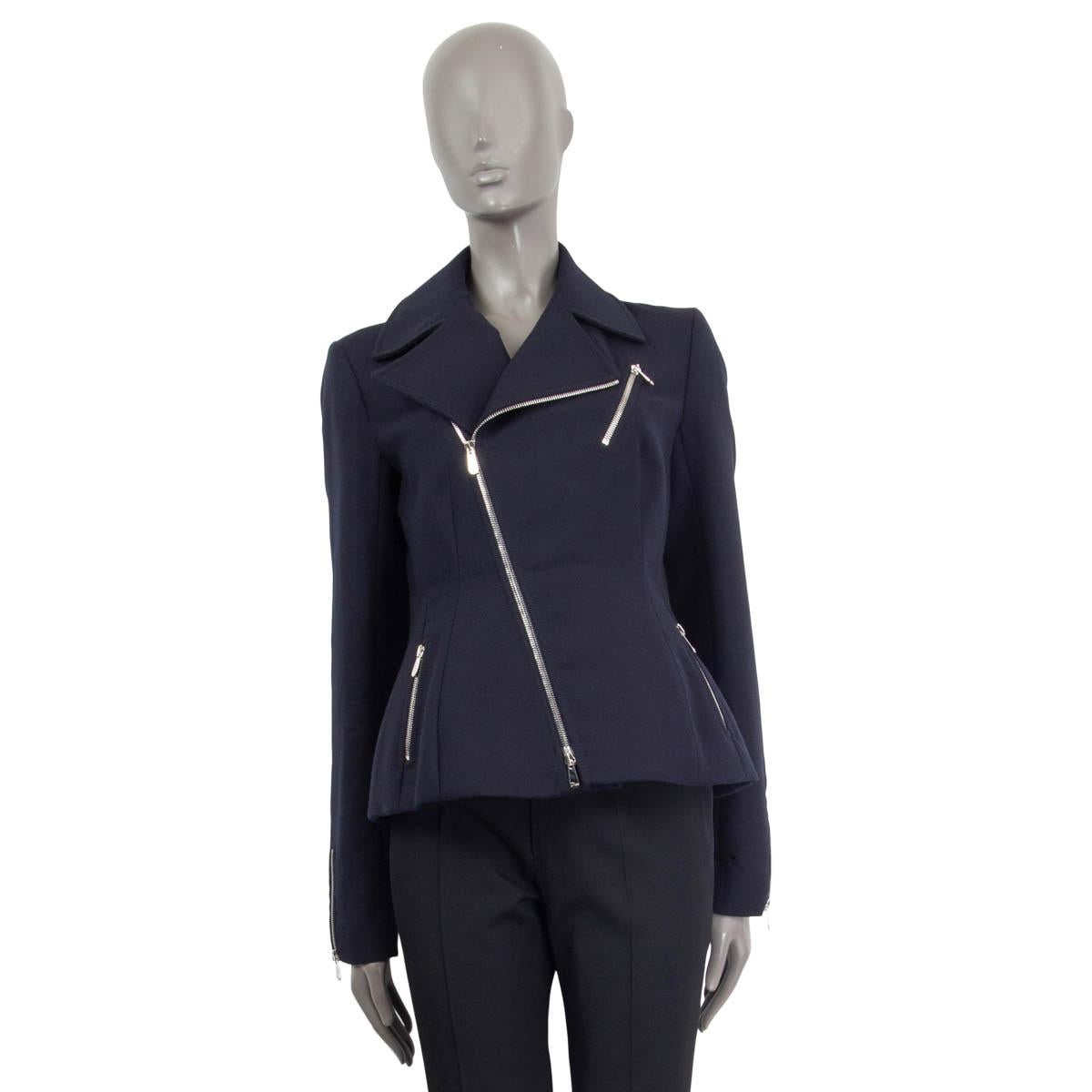 100% authentic Christian Dior tailored biker jacket in navy blue wool (100%). Comes with a notch collar, zipped cuffs and three silver zip pockets on the front. Opens with a diagonal silver metal zipper on the front. Lined in silk (100%). Has been