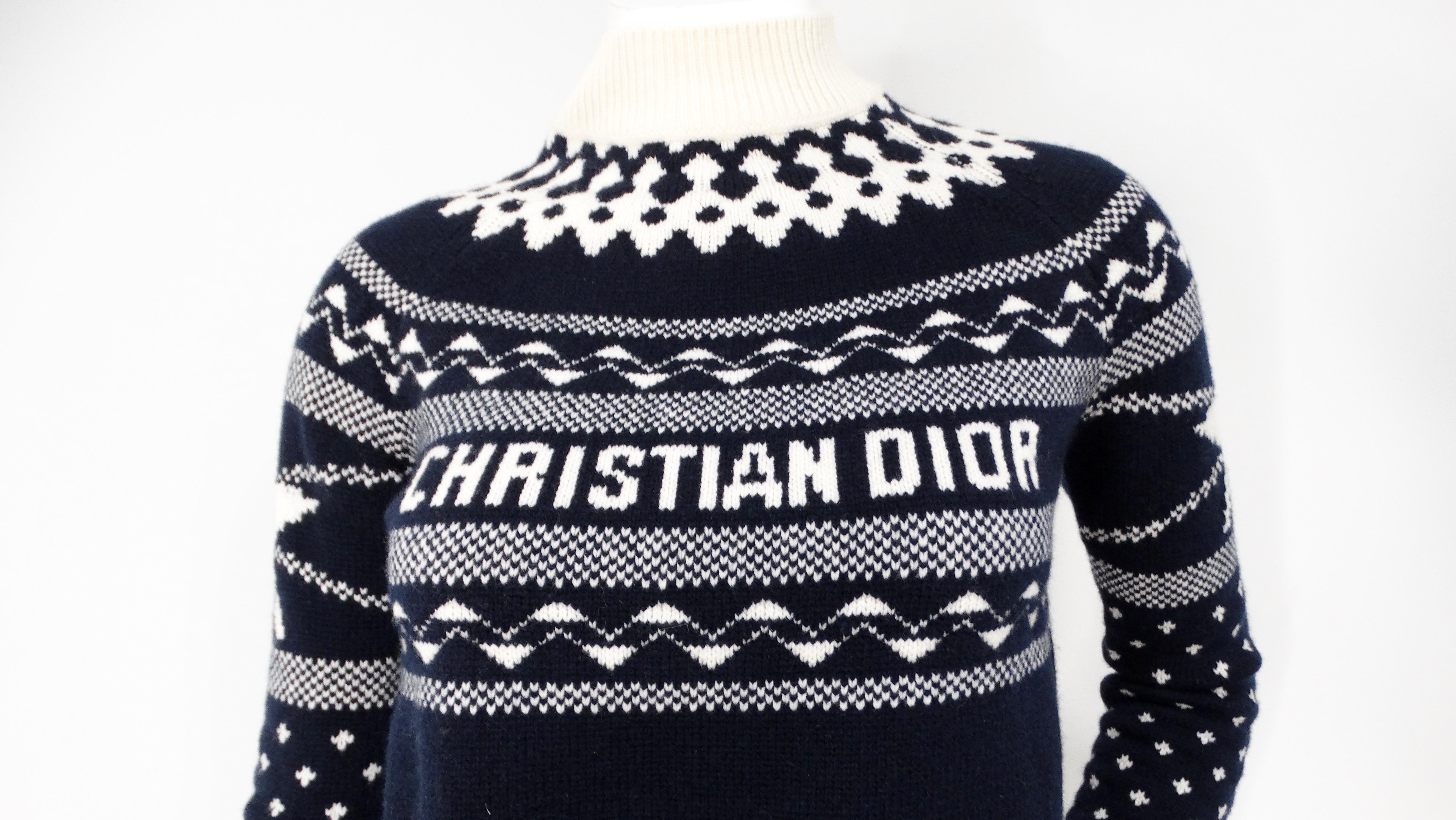 The Christian Dior Navy & White Wool Cashmere Blend Knit Pullover Sweater encapsulates timeless elegance and sophistication, making it an essential piece for any fashion-forward wardrobe. The luxurious blend of wool and cashmere ensures both warmth