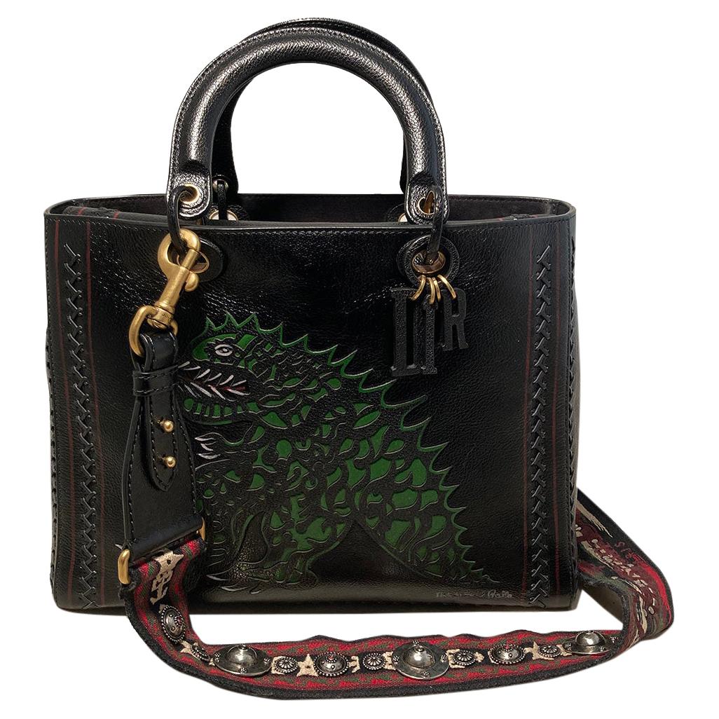 Christian Dior Limited edition Niki de Saint Phalle Large Lady Dior Bag and scarf in excellent like-new without tags condition. Black leather exterior trimmed with black and brass hardware and a limited edition dragon cut out in green leather along