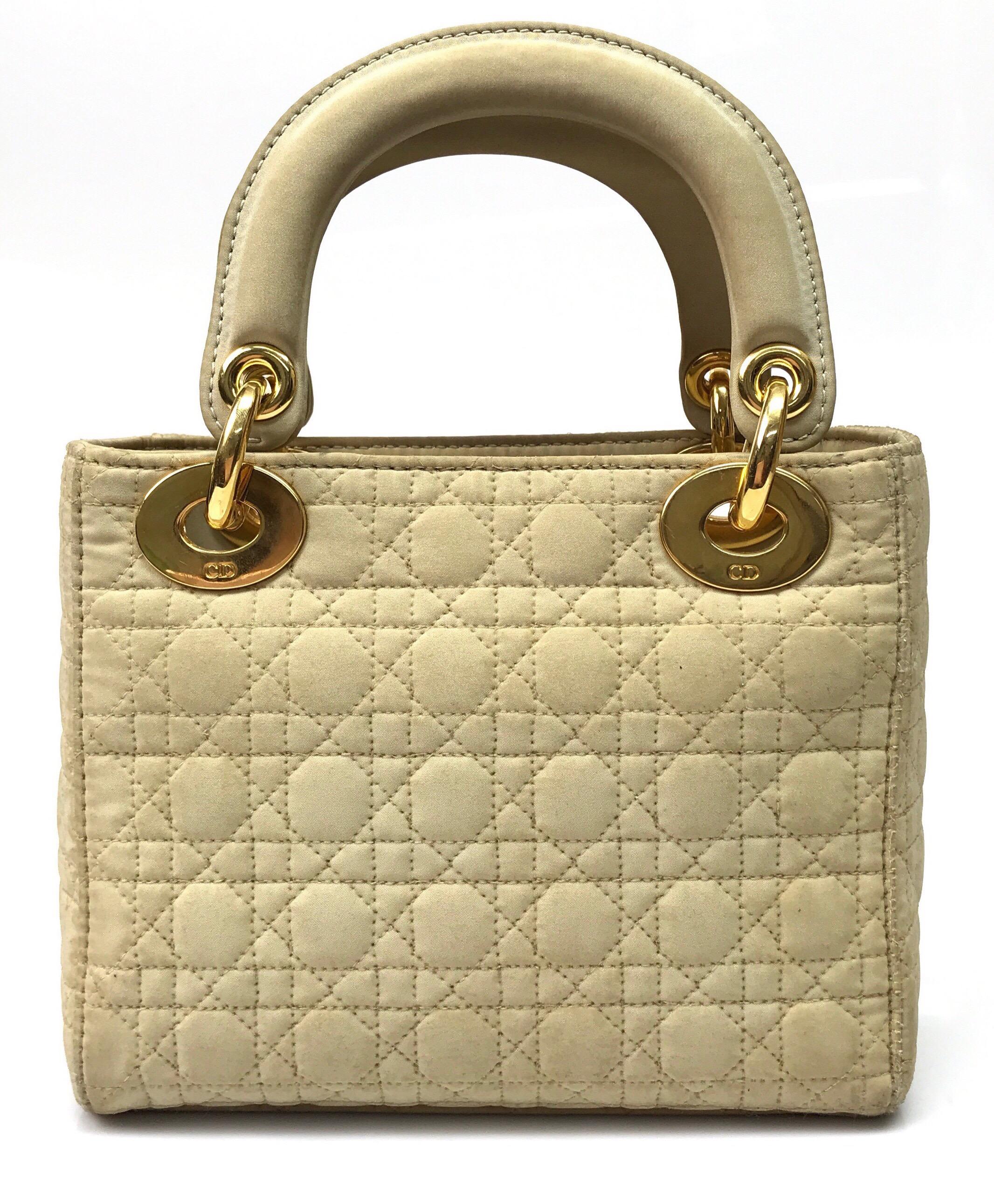 CHRISTIAN DIOR  Nude Fabric Small Lady Dior Handbag. This adorable Christian Dior Lady Dior  handbag is in good condition. The item does show some sign of use with some fading of the leather and aging that consists of a sticky feeling throughout the