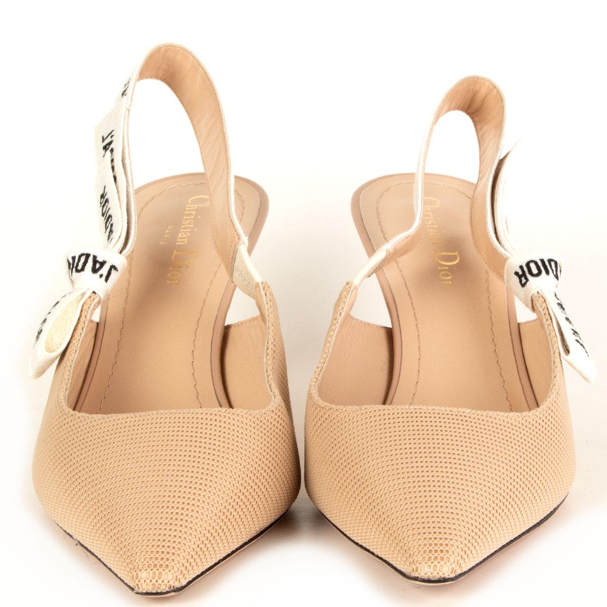 100% authentic Christian Dior J'Adior slingback pumps in nude technical fabric featuring J'ADIOR' two-tone embroidered cotton ribbon embellished with a flat bow. Lined in nude lambskin. Have been worn and are in virtually new condition. Come with