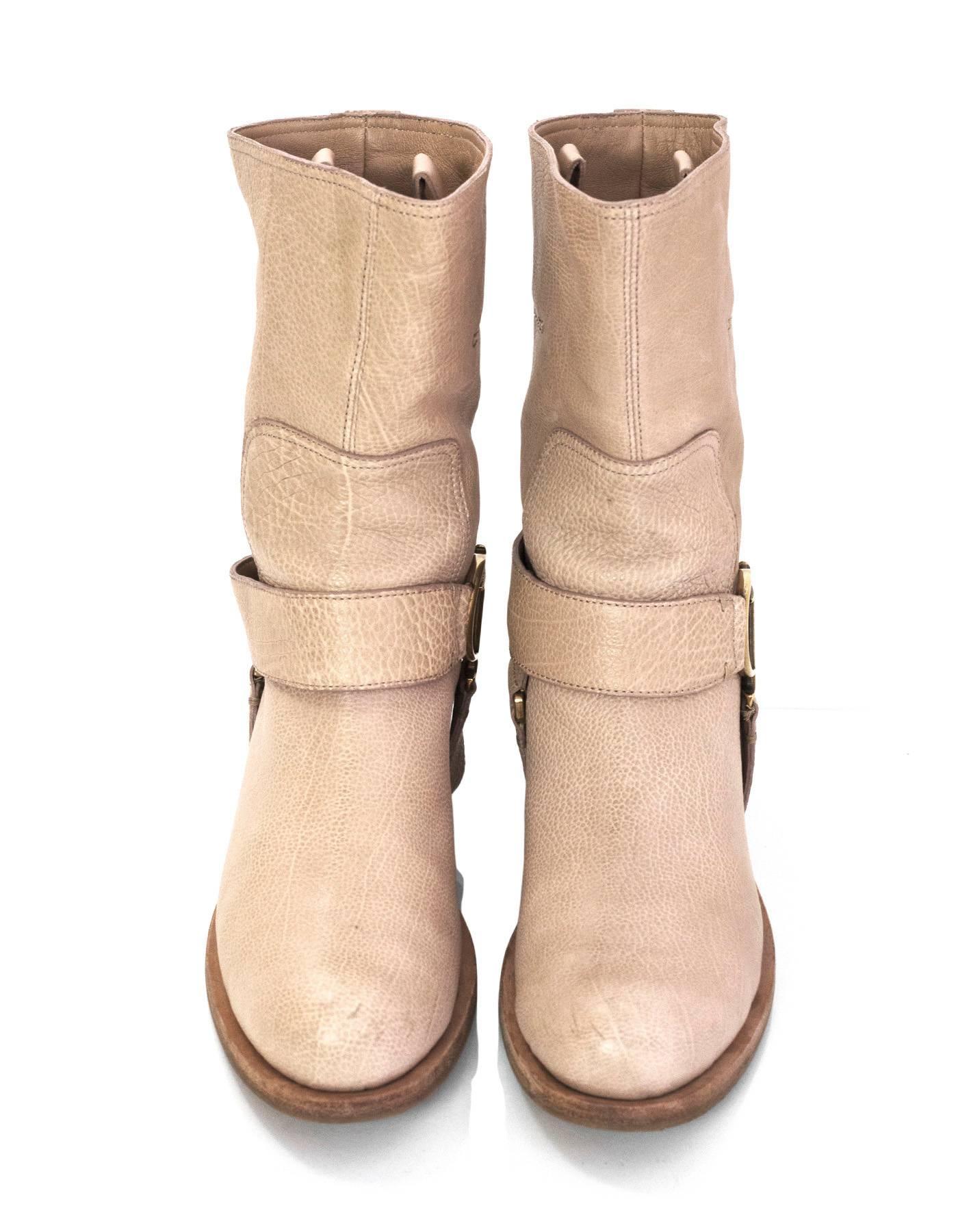 Christian Dior Nude Leather Short Boots  
Features removable CD logo buckle strap

Made In: Italy
Color: Nude
Materials: Leather 
Closure/Opening: Pull on
Sole Stamp: Dior Made in Italy 36
Overall Condition: Excellent pre-owned condition with the