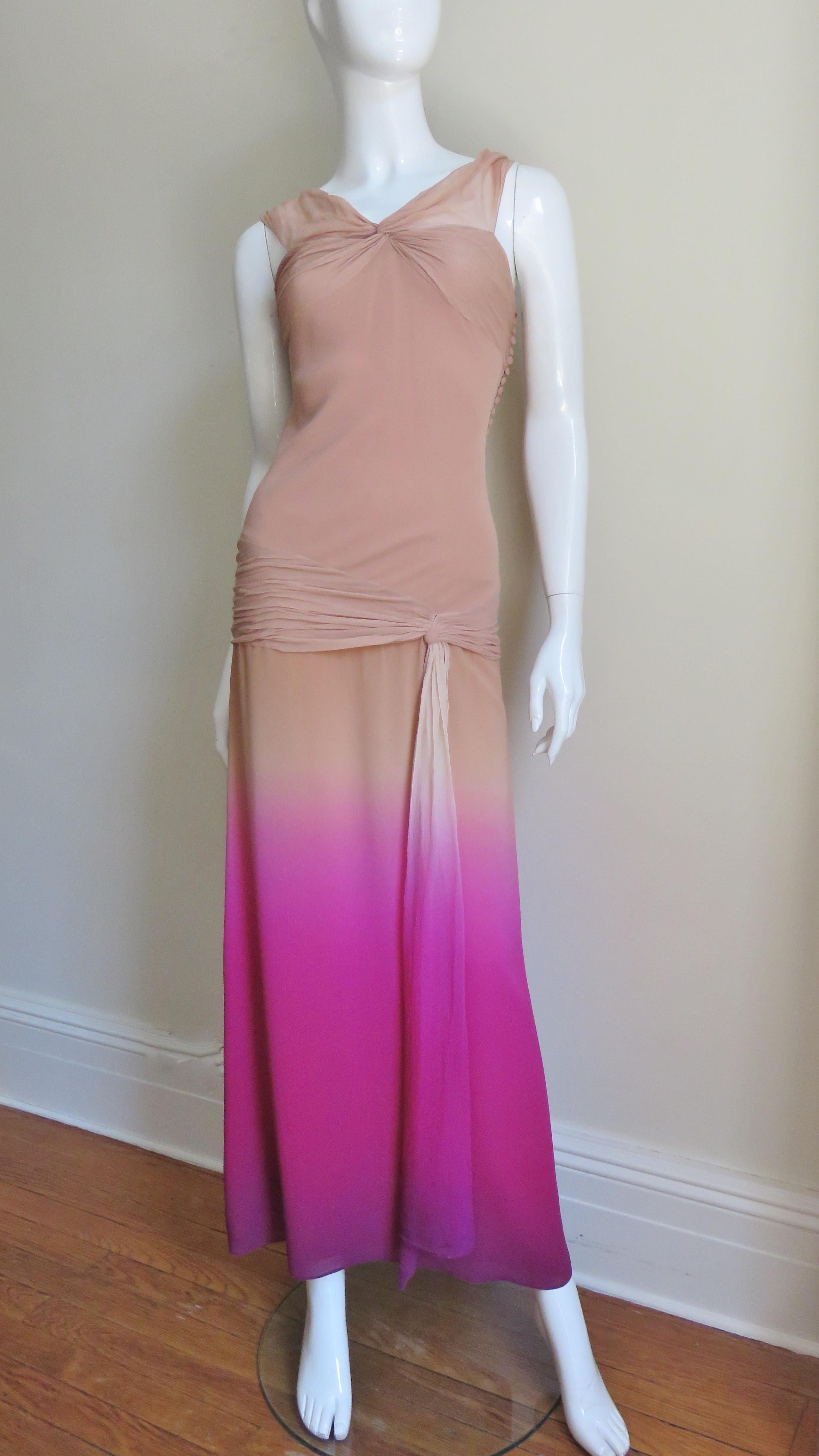 A gorgeous silk nude to bright pink ombre gown from Christian Dior.  It has ruching across the bust line and upper back, straps and around the hips with tie draping off center front along the skirt.  It has the signature Dior small self covered