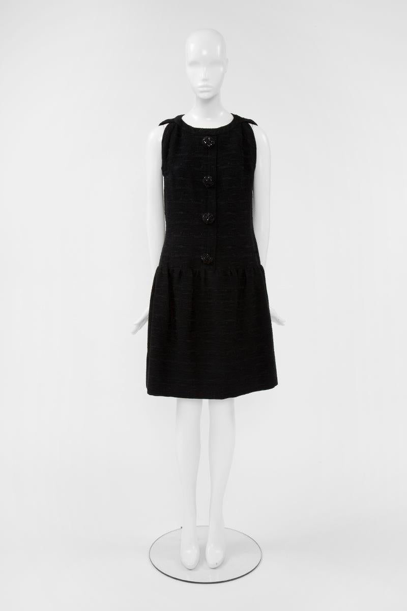 Is this 60’s Christian Dior the perfect “Little Black Dress” that every woman should have in her dressing ?! Constructed in a beautiful black “cloqué” silk, this textured cocktail dress features a round neckline which is framed with a refined and