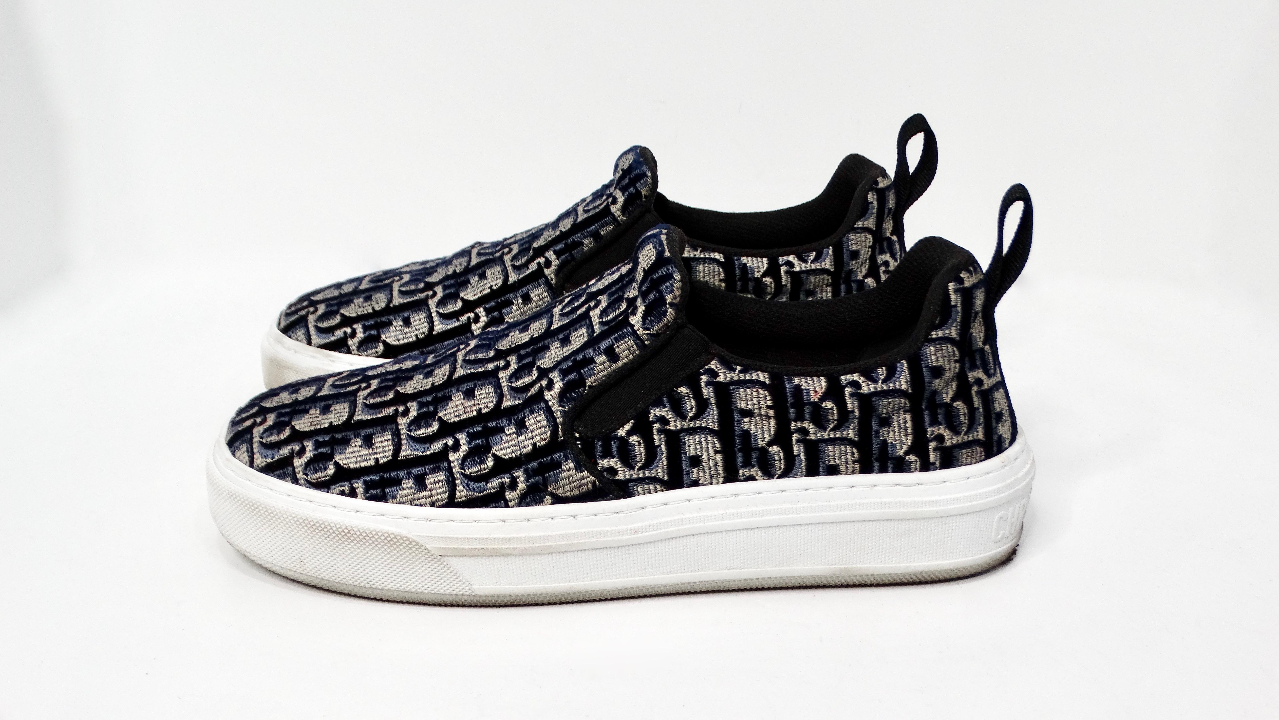 The Christian Dior Oblique Navy Monogram Slip-On Sneakers are a stunning blend of luxury and street style, crafted for those who appreciate high fashion without compromising on comfort. These sneakers feature Dior's iconic navy monogram, lending a