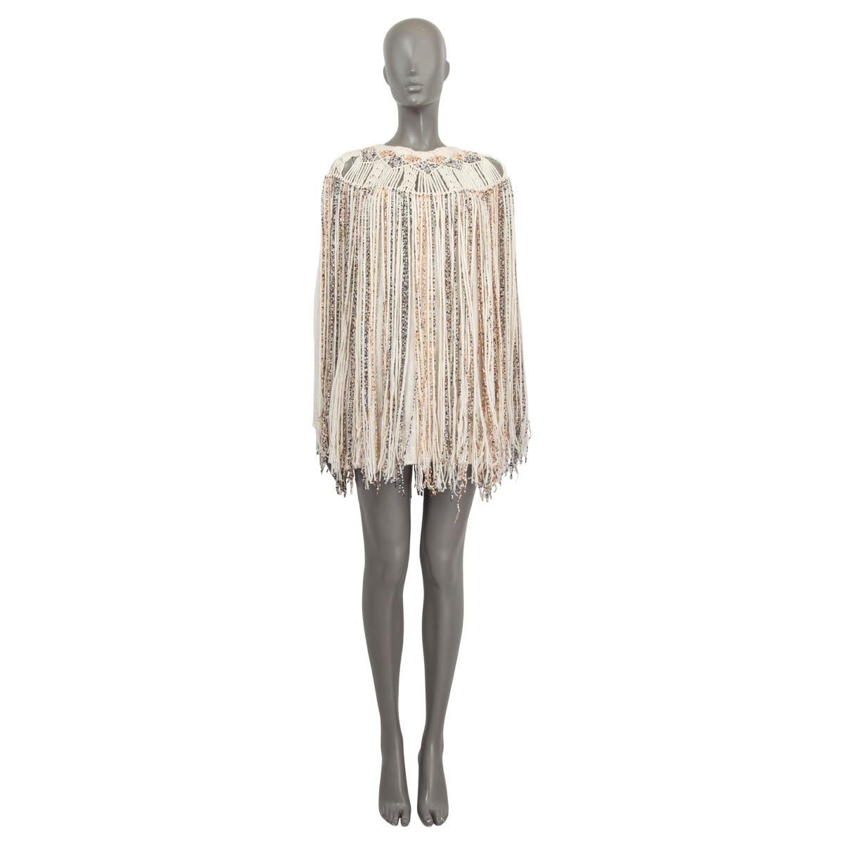 100% authentic Christian Dior knit dress in ivory cashmere (100%) with fringed details in copper, black, orange, yellow and gold cashmere (81%), polyamide (11%), viscose (5%) and cotton (3%). Opens with one button on the back neck. Unlined. Has been