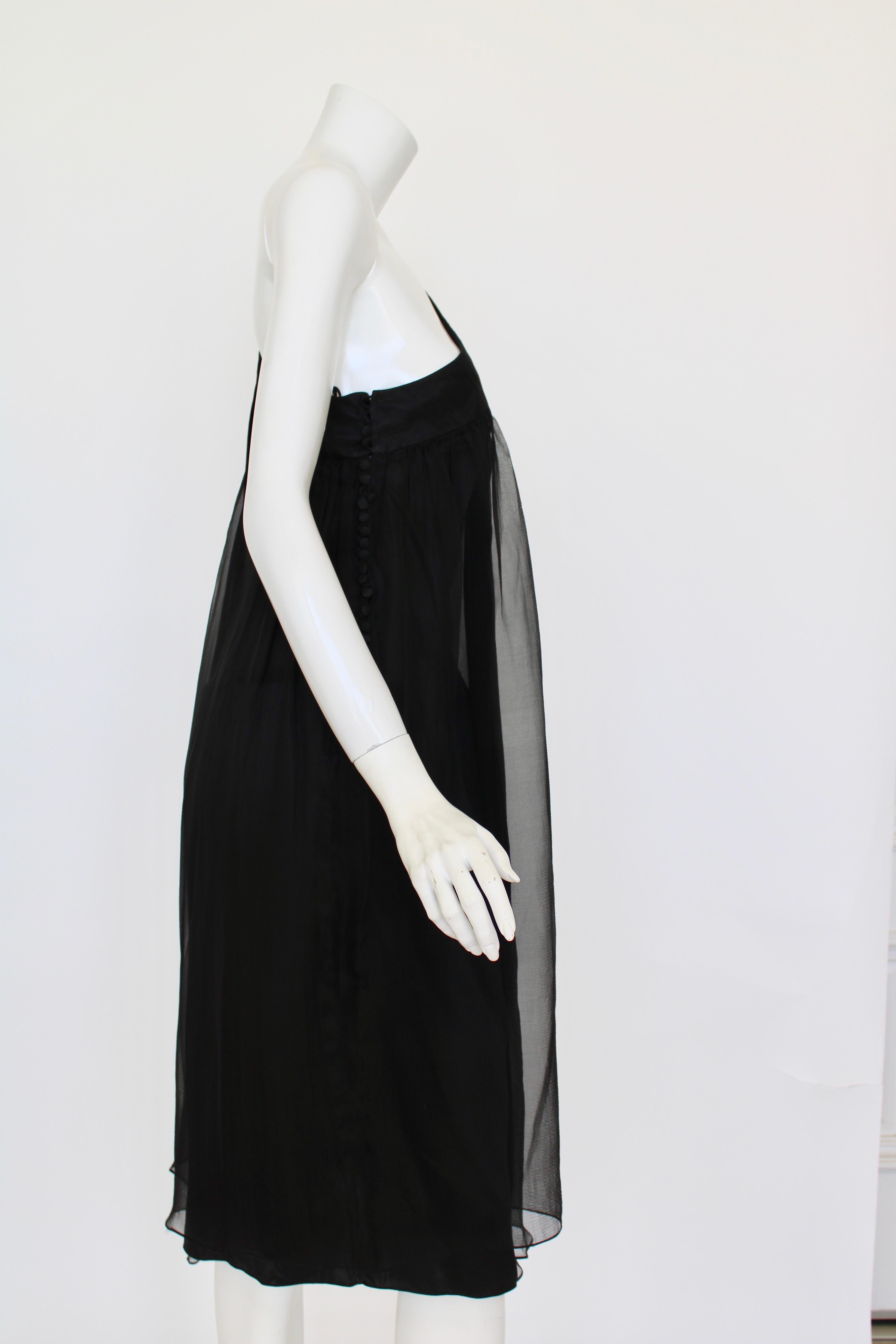 A beautiful and ethereal one shoulder dress from Christian Dior comprised of layers of sheer black silk. It has one shoulder with 2 panels of softly gathered silk falling and overlapping which can drape over the arm or leave it exposed. There is an
