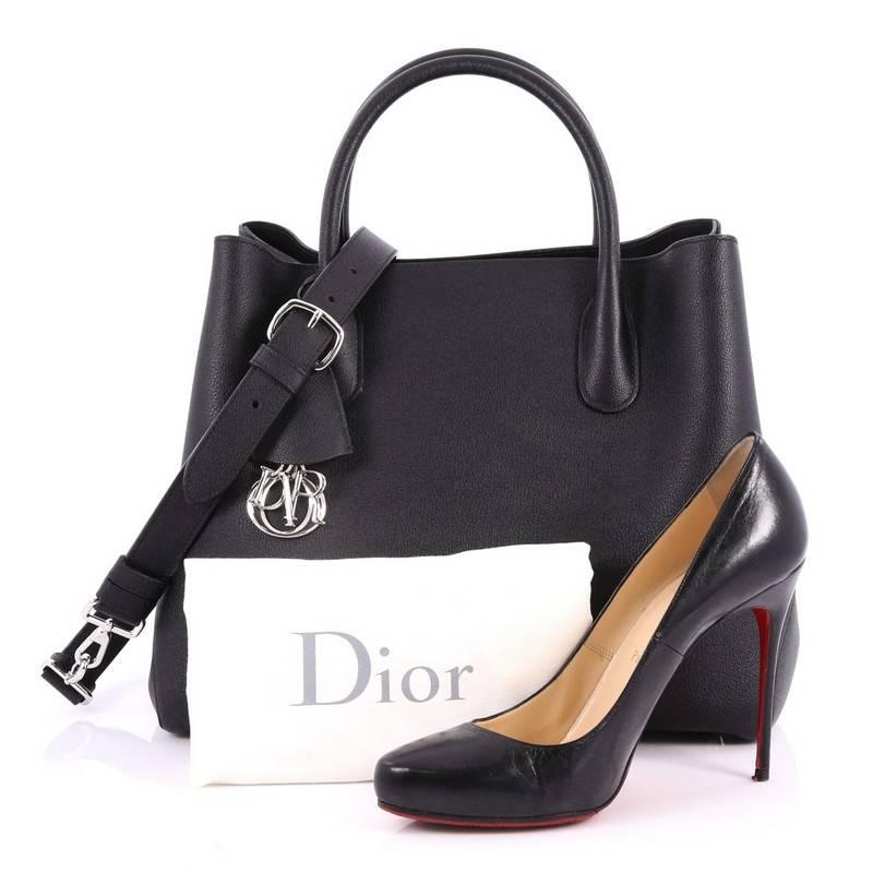 This authentic Christian Dior Open Bar Bag Leather Large takes inspiration from the brand's iconic Dior Bar jacket. Crafted in beautiful black leather, this impeccably chic tote features a soft-structured design, dual-rolled handles, protective base