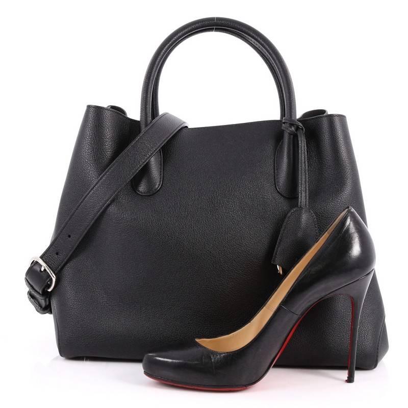 This authentic Christian Dior Open Bar Bag Leather Large takes inspiration from the brand's iconic Dior Bar jacket. Crafted in beautiful black leather, this impeccably chic tote features a soft structured design, dual-rolled handles, protective base