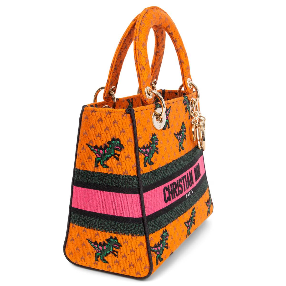 100% authentic Christian Dior 2021 Lady D-Lite Medium tote in orange dragon and fire embroidered canvas with gold-tone hardware. Closes with a flap and magnetic snap on top. Unlined with an open pocket against the front and a zipper pocket against