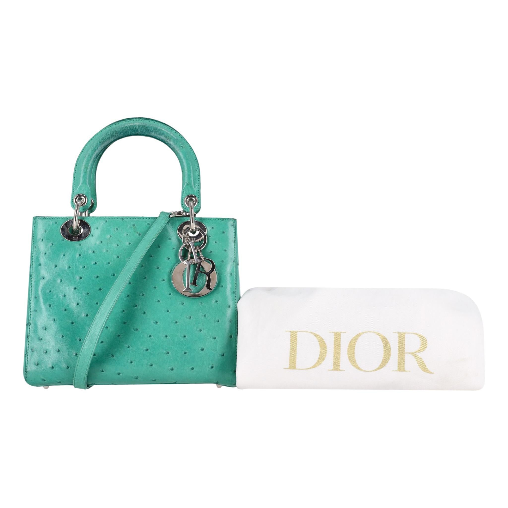 Christian Dior Ostrich Leather Medium Lady Dior Bag

Green bag crafted from ostrich leather with dual top handles and detachable shoulder strap.

Detailed with silver hardware, branded leather tag with signature 'DIOR' logo dangle charm and zipper