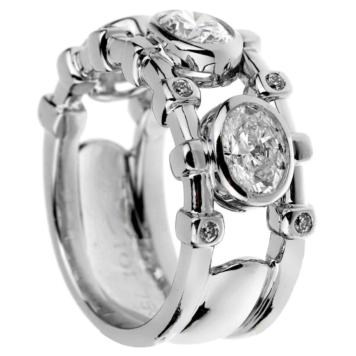 An amazing Christian Dior diamond cocktail ring showcasing 3 large round oval diamonds adorned with 8 round brilliant cut diamonds in shimmering 18k white gold. 

The ring measures a size 5 3/4 and can be resized.
Diamond Weight 1.56ct

