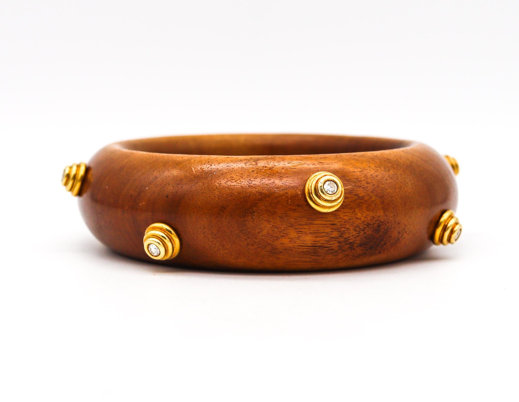 Wood bangle designed by Christian Dior and Georg Jensen & Wendell.

Beautiful vintage runaway bold piece, created by the fashion house of Christian Dior, back in the early 1960. Created with carved rose wood and accented with geometric elements