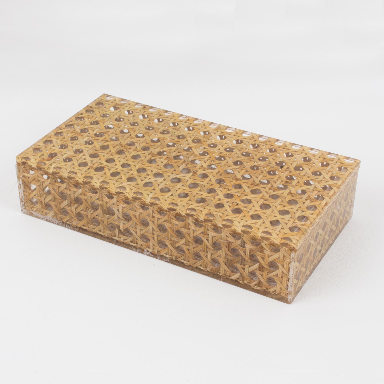 A charming modernist 1970s Lucite decorative box designed for Christian Dior Home Collection. Large rectangular shape with real rattan (or wicker) cane work embedded in the crystal clear Lucite. Great accessory for any modern interior.
Measurements: