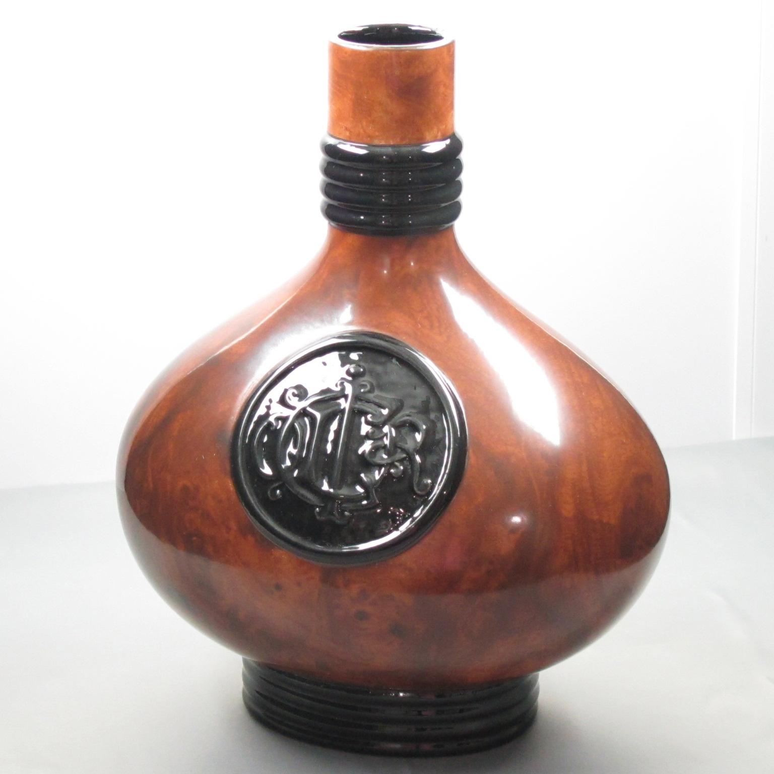 This stunning Christian Dior Paris Amphora ceramic vase from the 1980s is a beautiful accent piece for any room. The glossy ceramic has a unique faux burl wood textured pattern with black detailing and is finished with an ornate large 