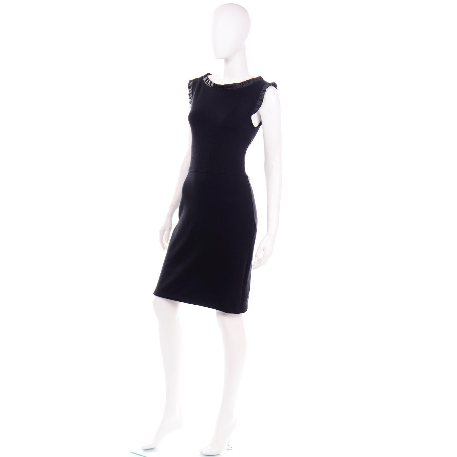 This is an incredible Christian Dior cashmere, wool, silk knit blend sheath dress with a leather ruffled trim. This chic sleeveless dress has a bateau neckline and closes with a side metal zipper. This is a timeless little black dress that can be