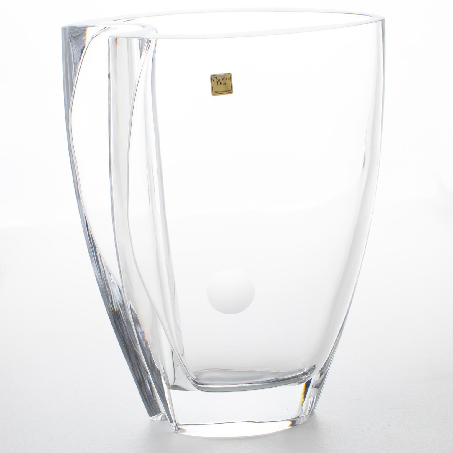 This superb crystal vase was designed for the Christian Dior Home Collection in Italy in the 1980s. The monumental glass art piece has a smooth, streamlined, minimalist, wavy shape with a frosted etched dot on one side. The vase is heavy and sturdy