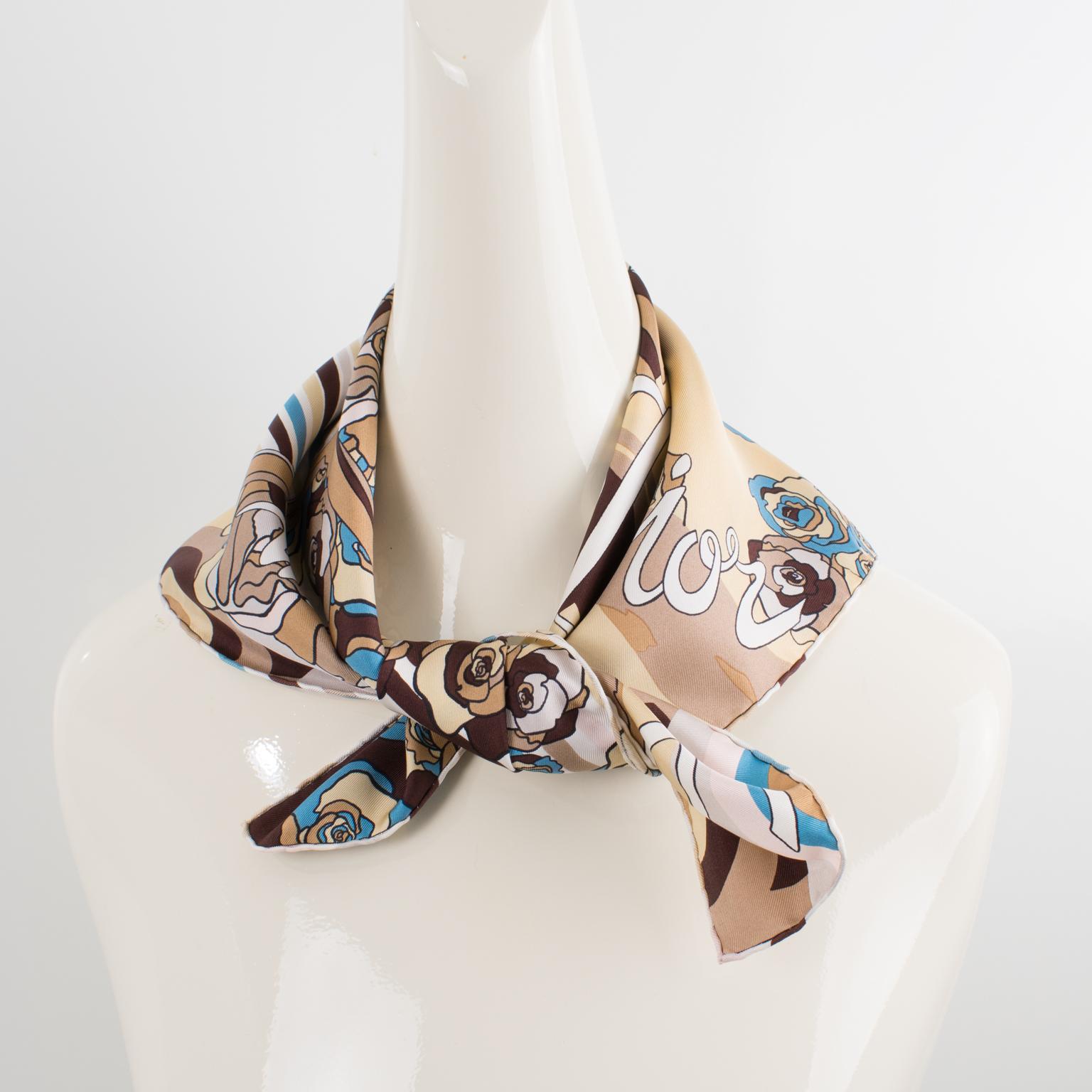 This beautiful silk scarf by Christian Dior in blue and beige colors features the iconic Dior chair design print with a large Christian Dior signature name blending into the design. The combination of colors is bright and vibrant, with pale pink,