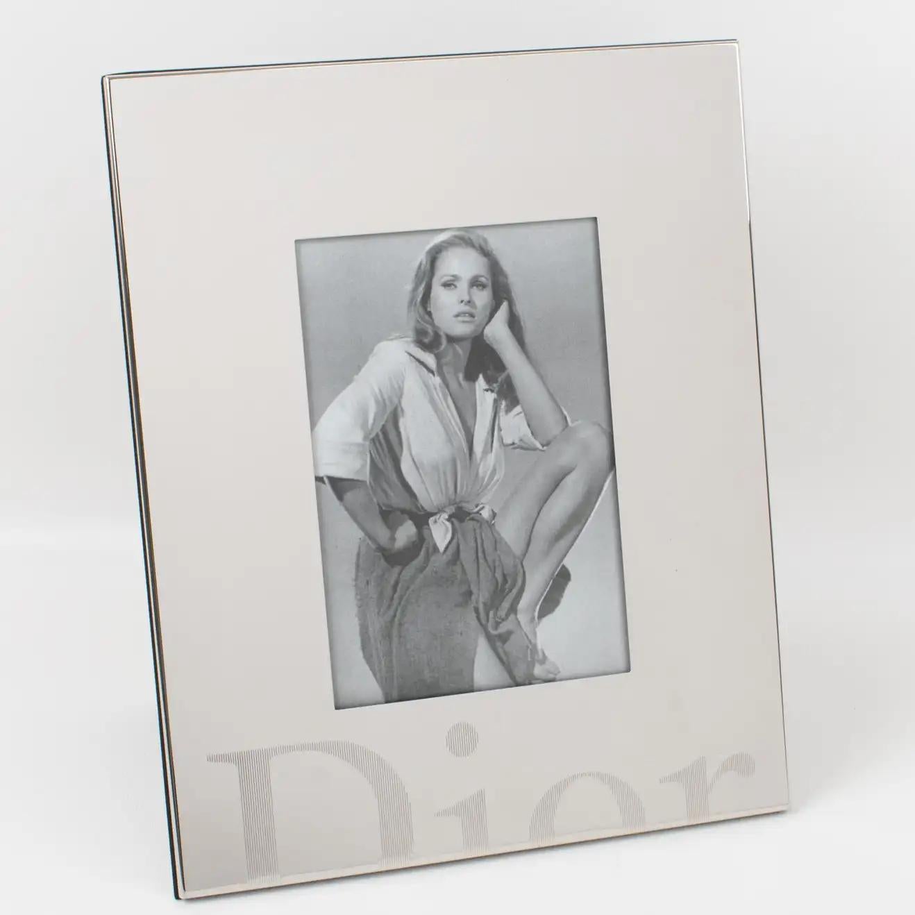 A gorgeous Christian Dior Paris silver plate picture photo frame. The piece boasts a geometric plain shape with the 