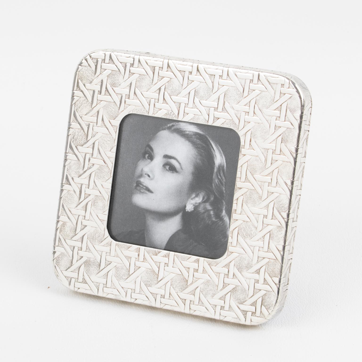 An adorable Christian Dior Paris sterling silver picture frame. Square shape with embossed caning pattern all around. The textured cane-work pattern is one of Christian Dior's most iconic designs. The company used that texture for numerous home