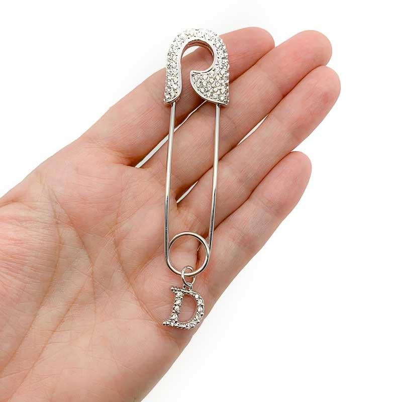 We absolutely adore this glamorous pin. A stunning Vintage Dior Safety Pin from the Galliano collections of the 2000s. Encrusted with pavé set crystals. Very definitely not your average safety pin. With a lovely crystal D for Dior charm dangling