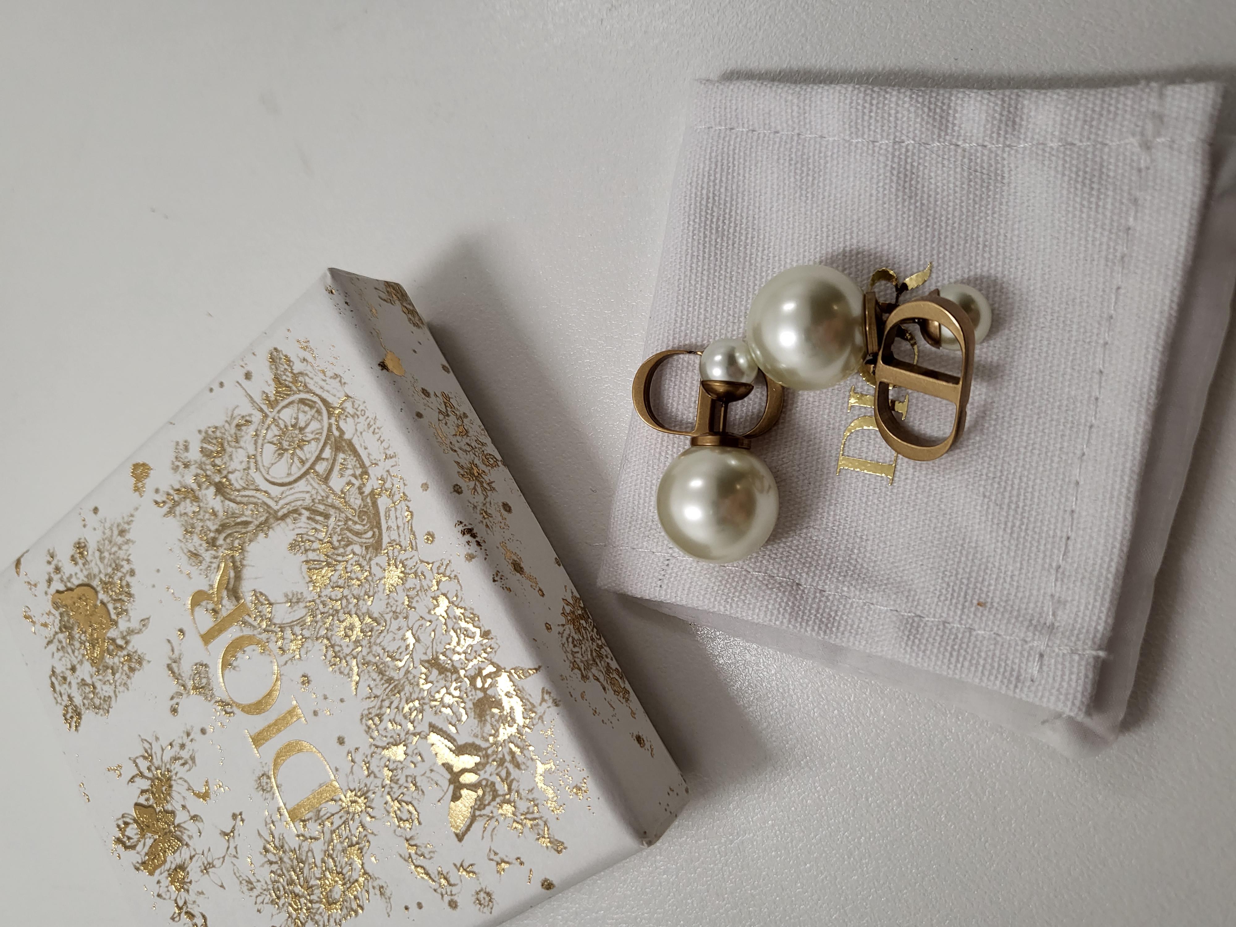 Enhance your elegance with the Christian Dior Pearl Tribales Antique Gold Earrings, a timeless fusion of sophistication and modern allure. Crafted with meticulous attention to detail, these earrings feature lustrous pearls delicately cradled in an