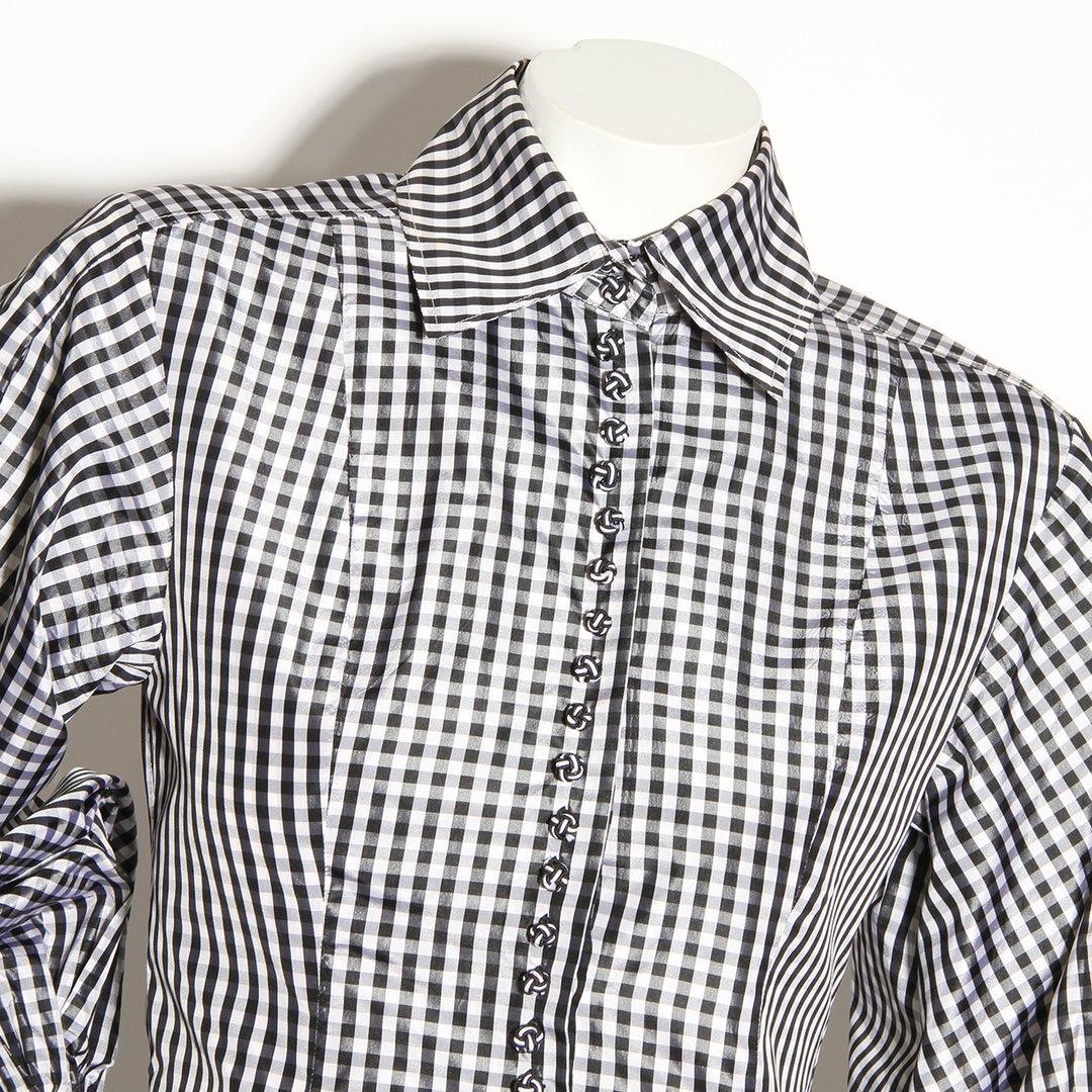 Checkered peplum top by Christian Dior
Black and white 
Checkered pattern
Balloon sleeve 
Button cuff closure 
Hidden Button-front closure 
Decorative faux buttons 
Pleated bottom
Made in France
Condition: Excellent, little to no visible wear.