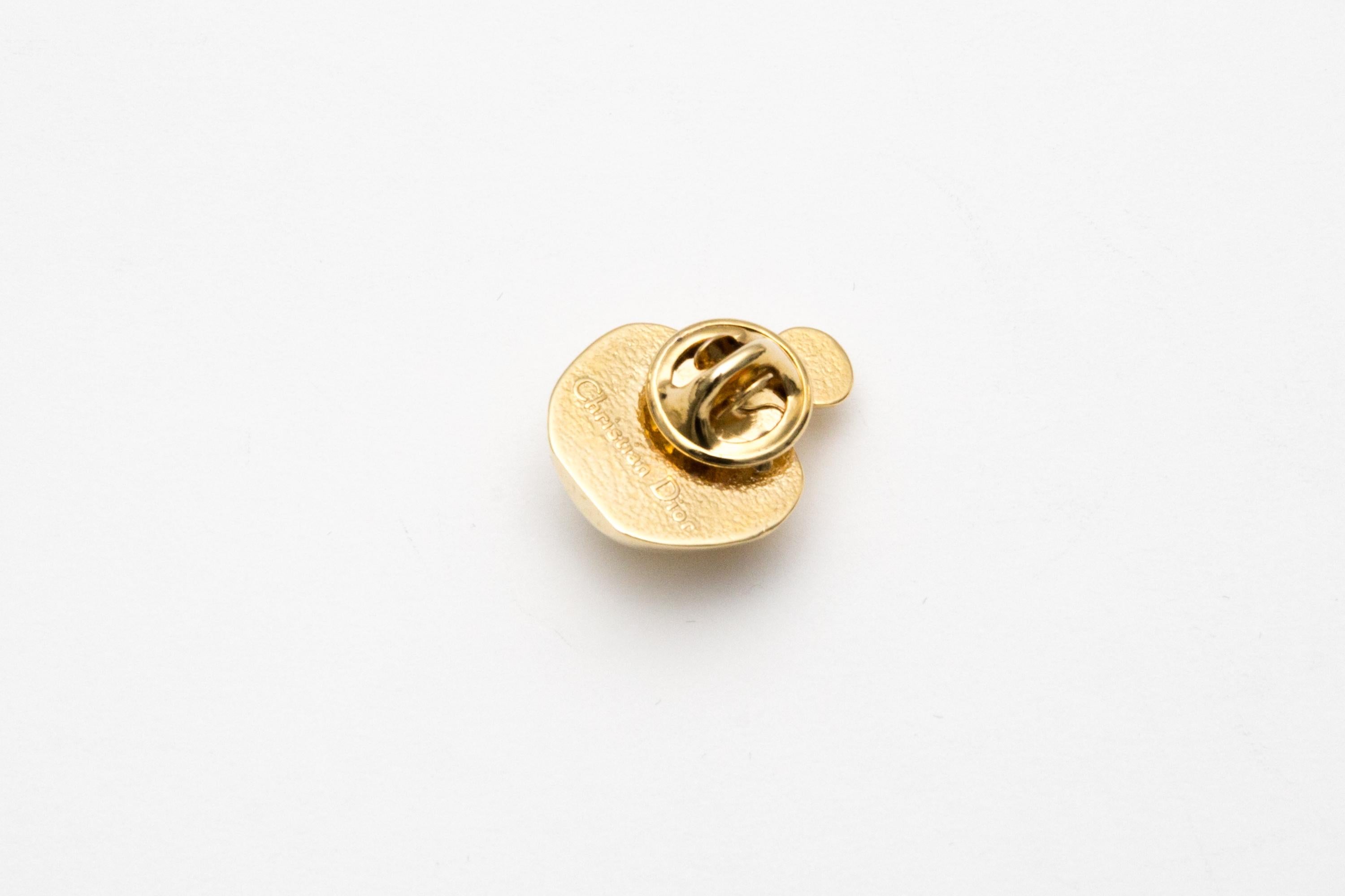 Christian Dior Gold-tone perfume bottle brooch pin featuring a front  “Poison” design, a back pin and a back pitted plaque.
Circa 1990s . Made in France
0.8in. (2cm)  X 1in (2.5cm)
Good vintage condition. Made in France.  
Please note this item is