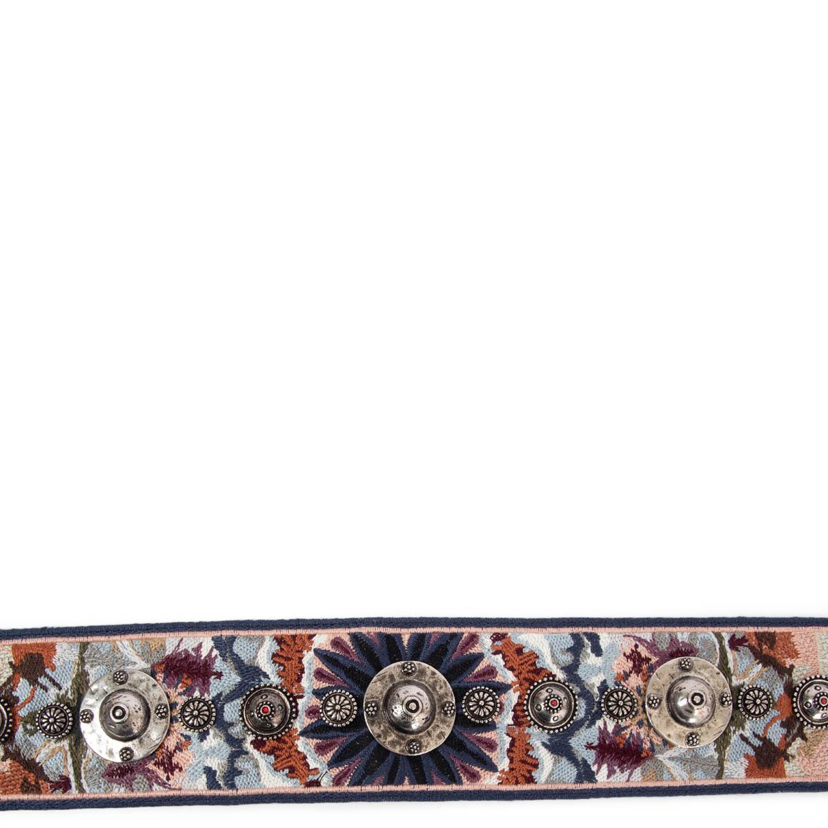 100% authentic Christian Dior KaleiDiorscopic belt trap with silver-tone studded metal emblems in nude, navy, brown, white and purple canvas featuring gold-tone clasps and black leather trimming. Has been carried and is in excellent condition.