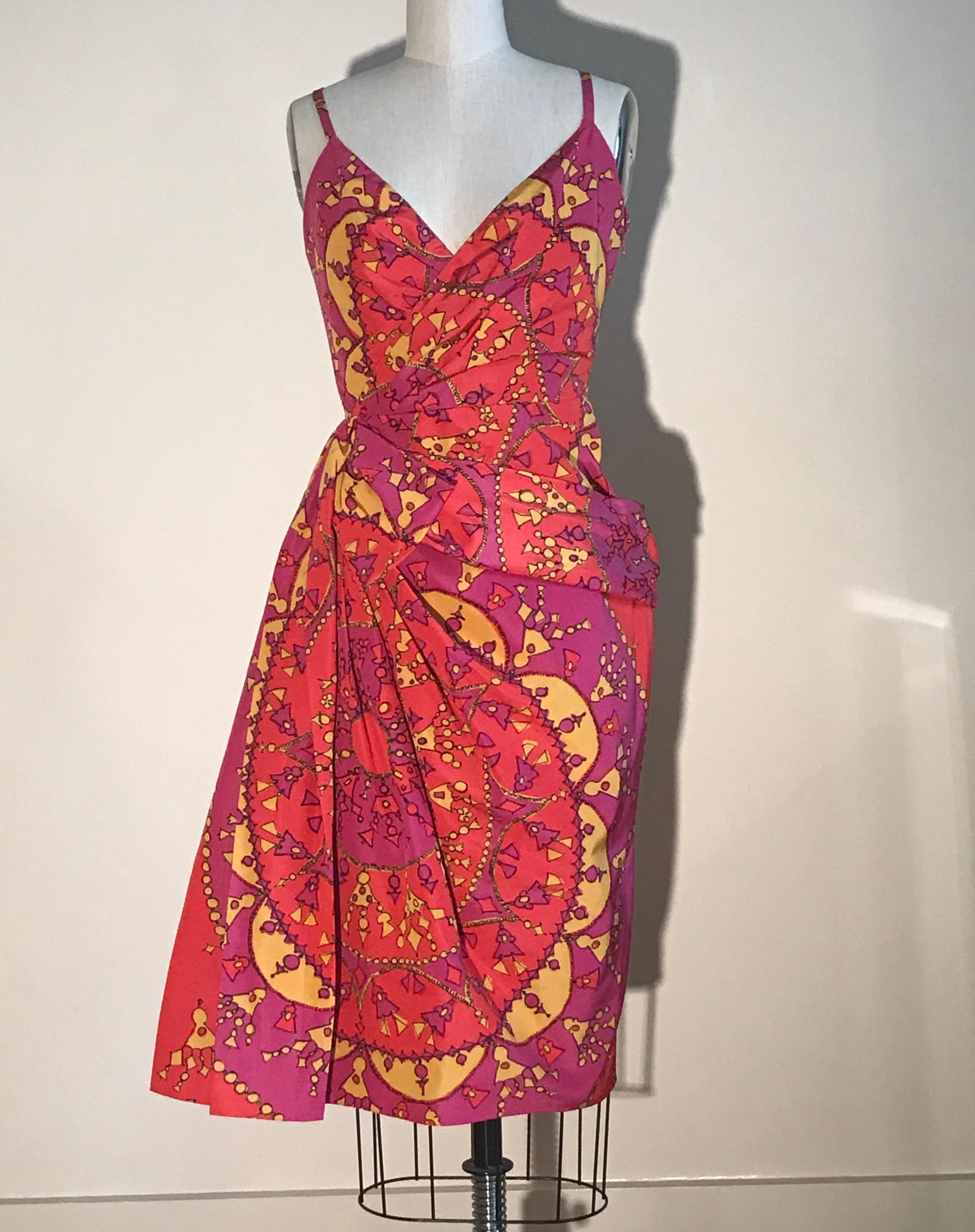 Christian Dior pink and yellow tassel pendant print dress from the spring 2008 collection. Draped detail creates volume at waist and a bow like flourish at side. Side zip and hook and eye.

51% cotton, 49% silk.
Fully lined in 100% silk.

Made in