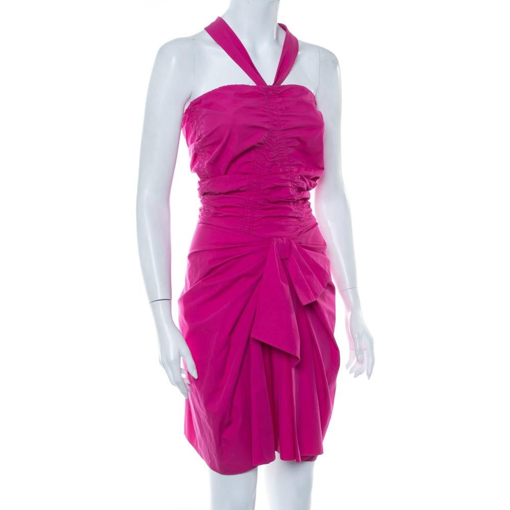 This Christian Dior strapless dress is a stunning choice for a perfect evening look. Tailored from pure cotton, it has a flattering, figure-skimming effect with ruching details and falls to a mini length. The halter neck, bow detailing and a zip