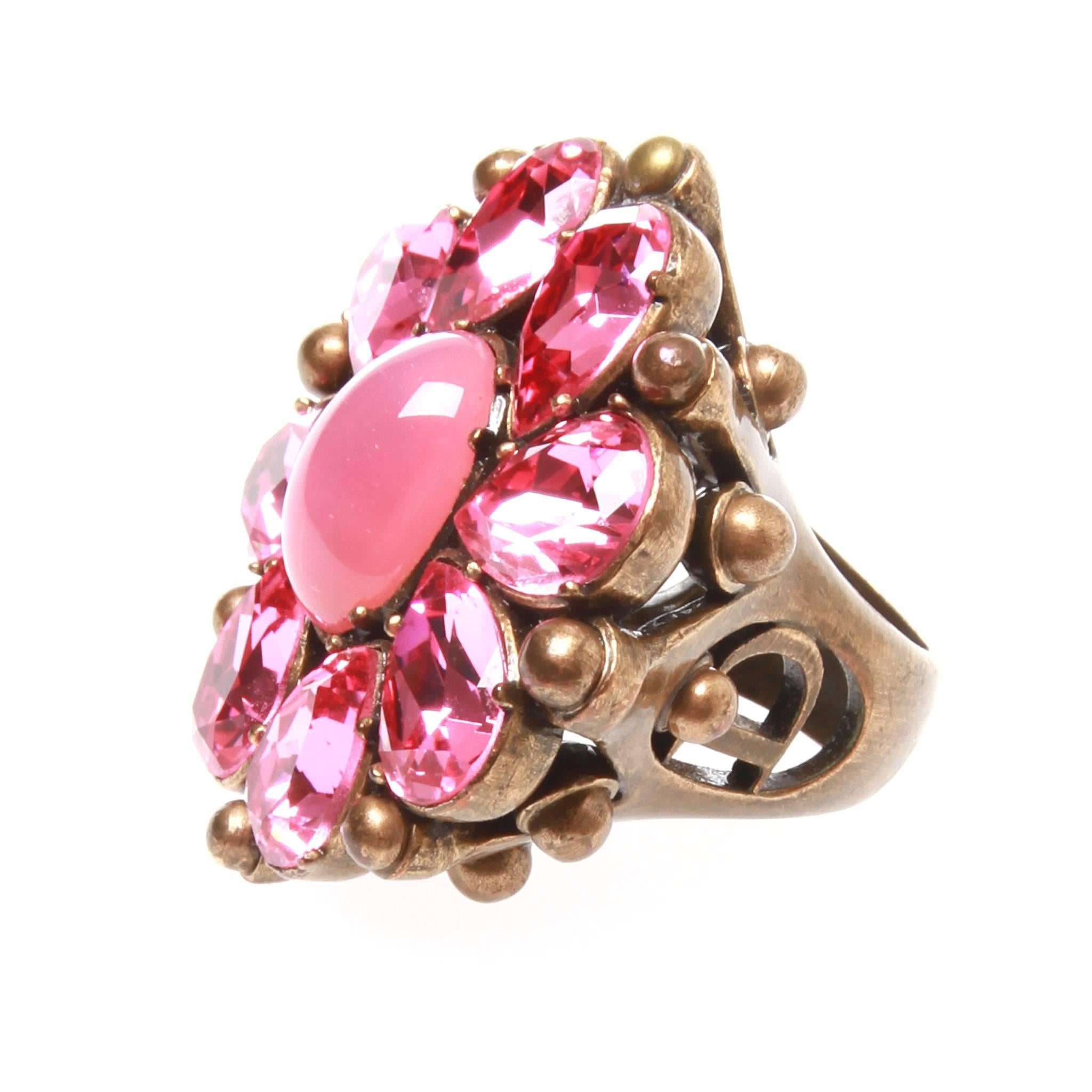 Absolutely stunning cocktail ring featuring pink rhinestones and an iridescent pink faux moonstone cabochon in the center with bronze brass setting and signature 