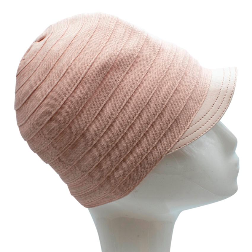 Christian Dior Pink Knit & Lambskin Hat

- Made of soft lightweight knit 
- Gorgeous pink hue 
- Lambskin details 
- Made of a single piece of knit ribbon 
- Timeless elegant design

Materials:
80% viscose, 20% nylon 

Made in France 

Approx.