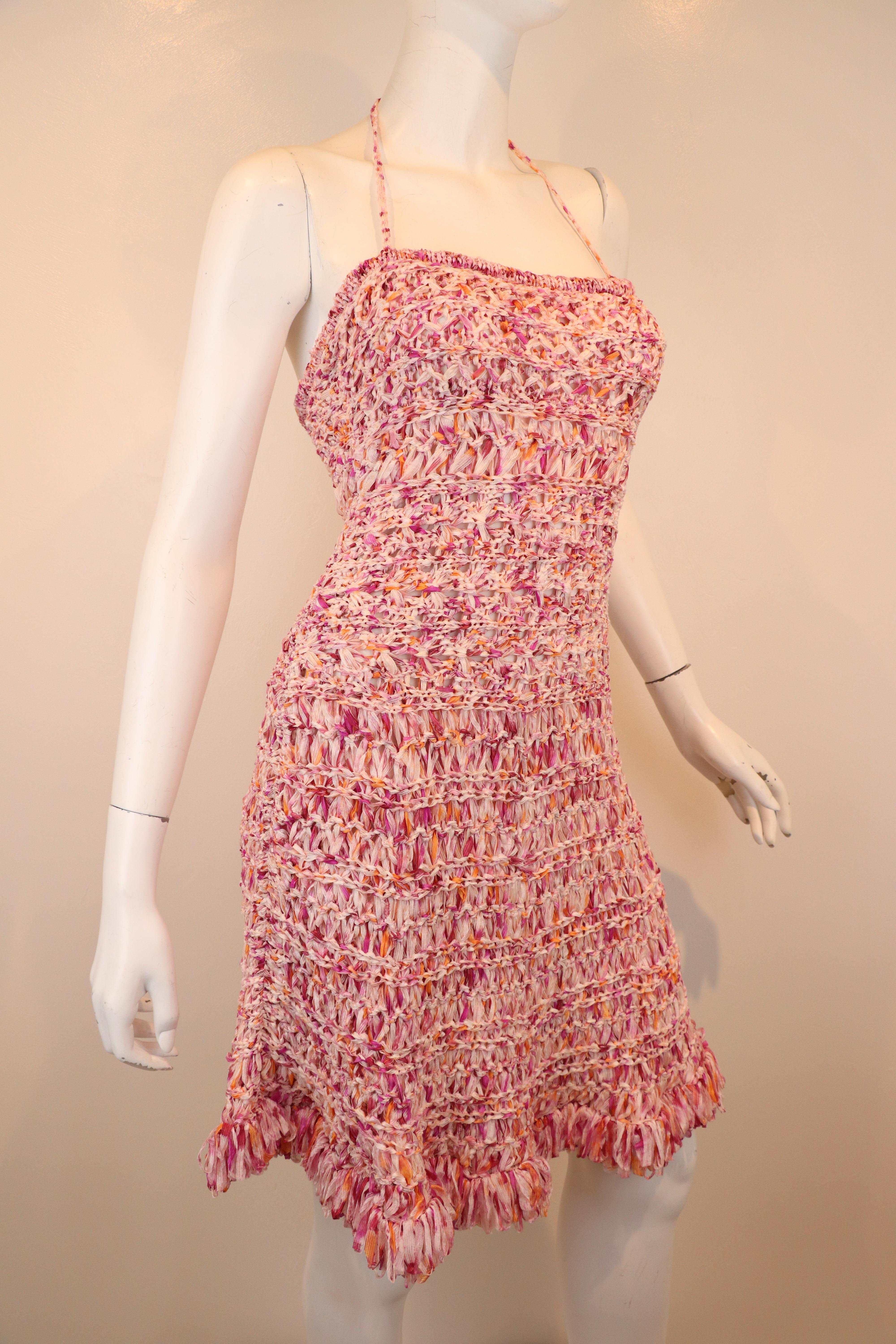 Beautiful Christian Dior fit and flare dress with pink and white woven ribbon with a fringe hem and two matching straps that tie as a halter on this amazing dress. France size 40. Made in France. Dress is in pristine condition.

Bust: 34