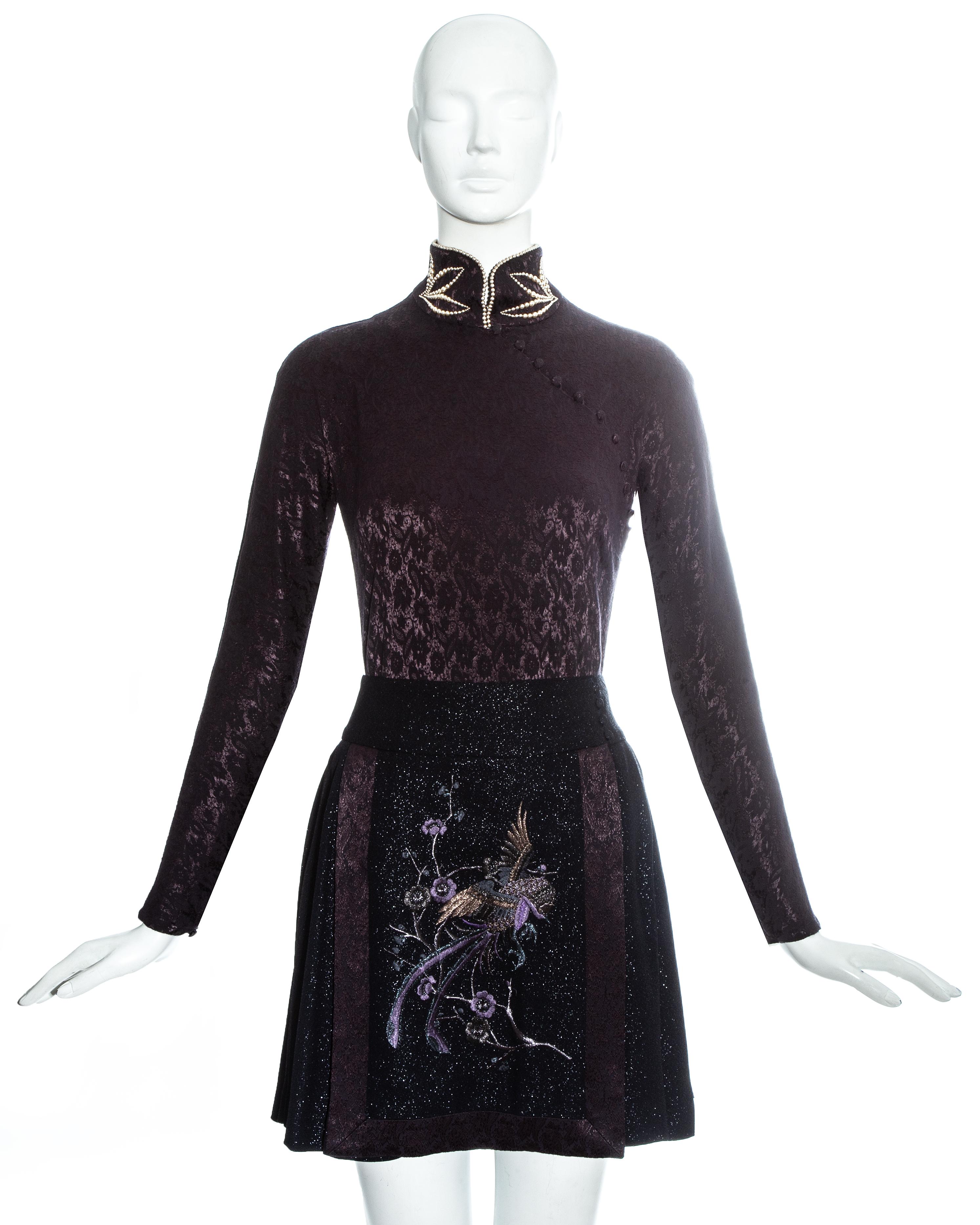 Christian Dior by John Galliano, plum jacquard satin cheongsam style bodysuit with fabric covered button fastenings and high neck with decorative faux pearls and hook and eye fastenings. Black lurex mini wrap skirt with matching plum jacquard satin