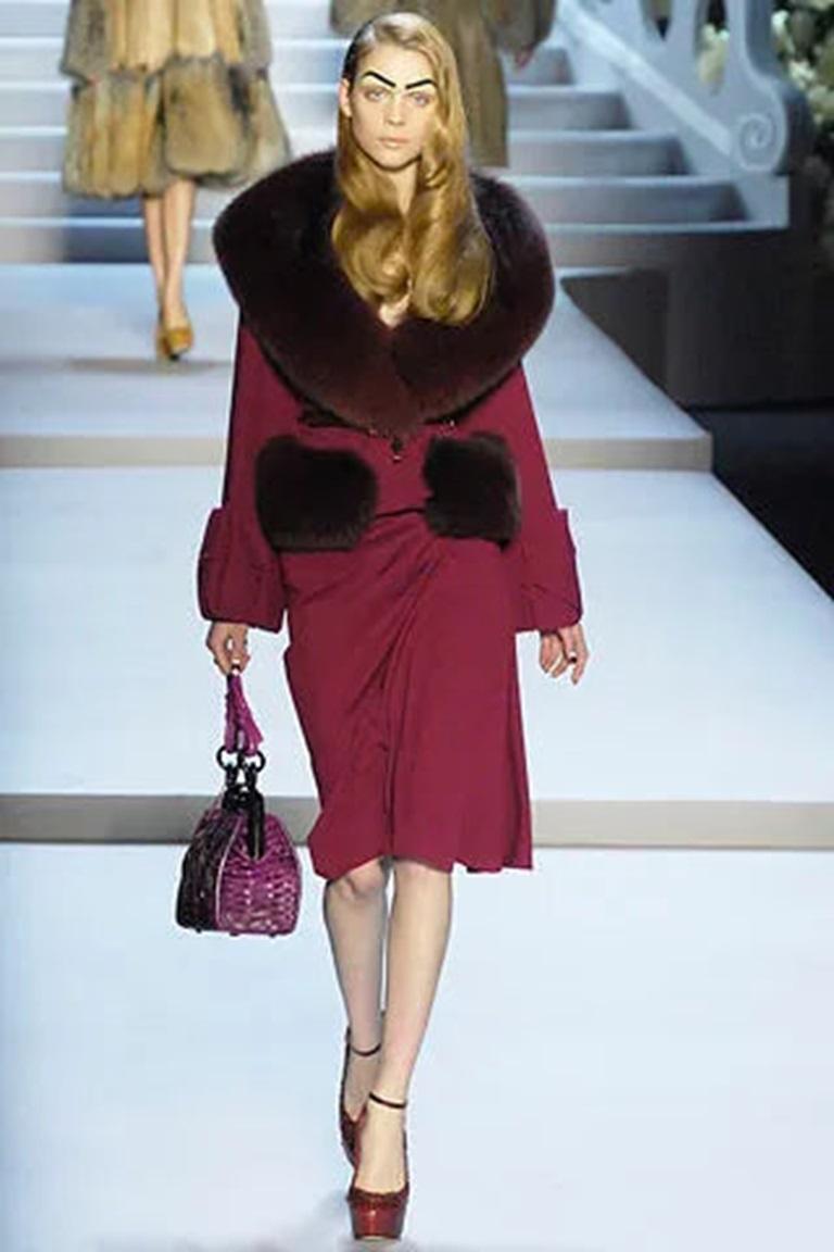 Dior - (Made in France) Plum new wool jacket with fox fur collar and pockets, and a silk lining. The jacket comes with a belt. Size 38FR indicated. 2007 Fall-Winter Collection, under the artistic direction of John Galliano.

Additional