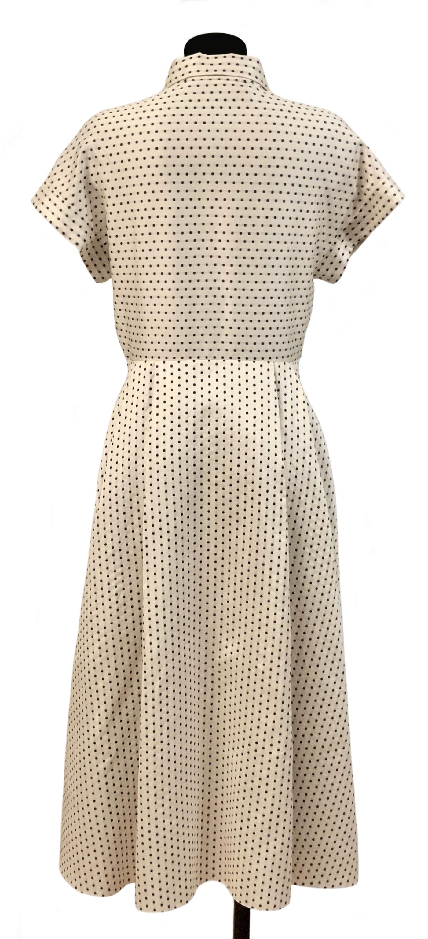 Beautiful dress from the Pre-Fall Collection 2020 from the house of Christian Dior.
Its is crafted from light silk and cotton jacquard in a soft ivory color with black polka dots.

It features a shirt type collar, short sleeves and front button