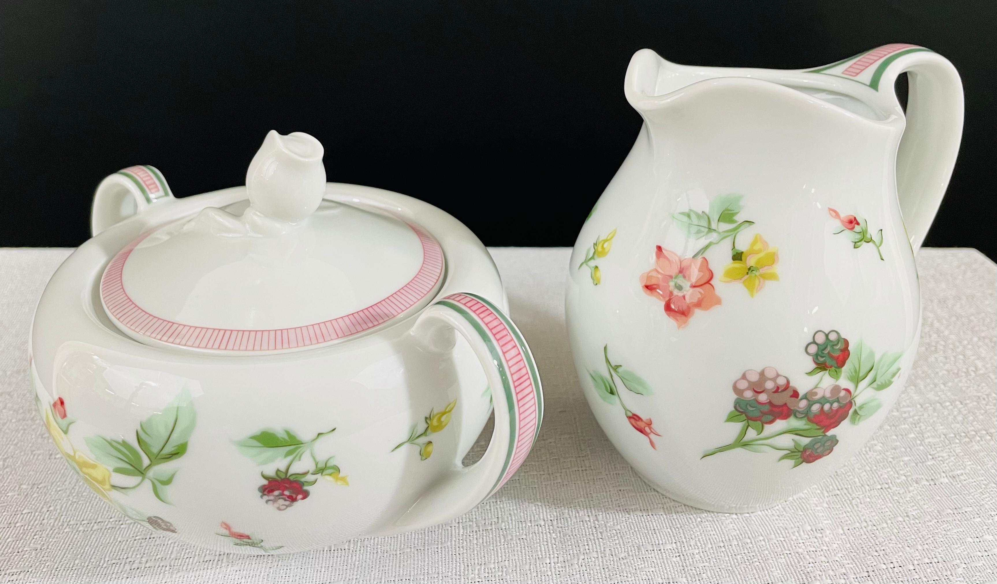 A Christian Dior Provence collection set of two porcelain pieces, a sugar bowl and a creamer. Both Christian Dior dishes feature exquisite floral design on white background and are signed in the bottom 