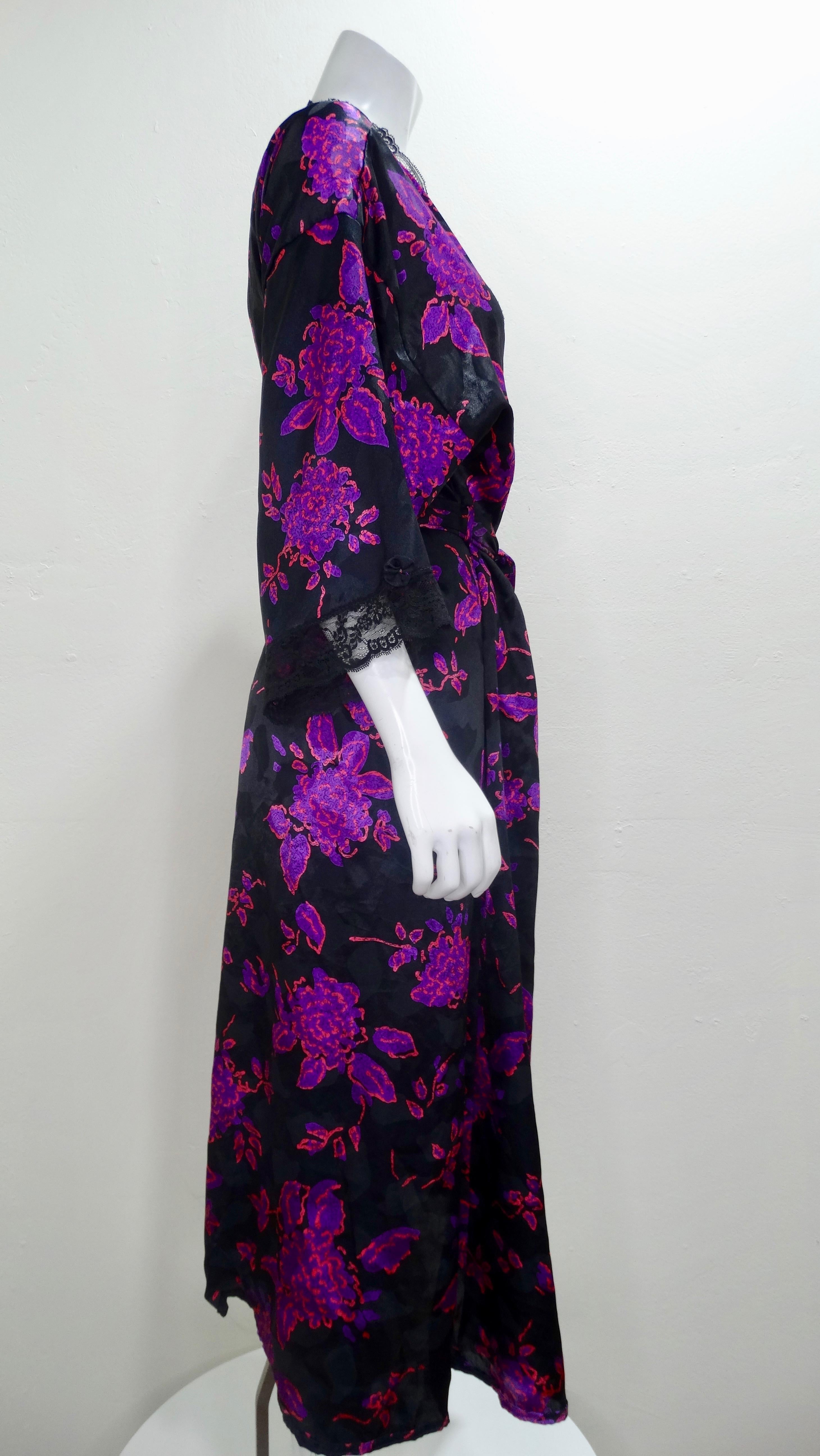 Whether you're going out or staying in, this Dior is for you! Circa 1980s, this black Silk wrap robe features a vibrant purple and pink abstract floral pattern with black lace trim. Sexy and chic, this lingerie piece can be worn on an evening out