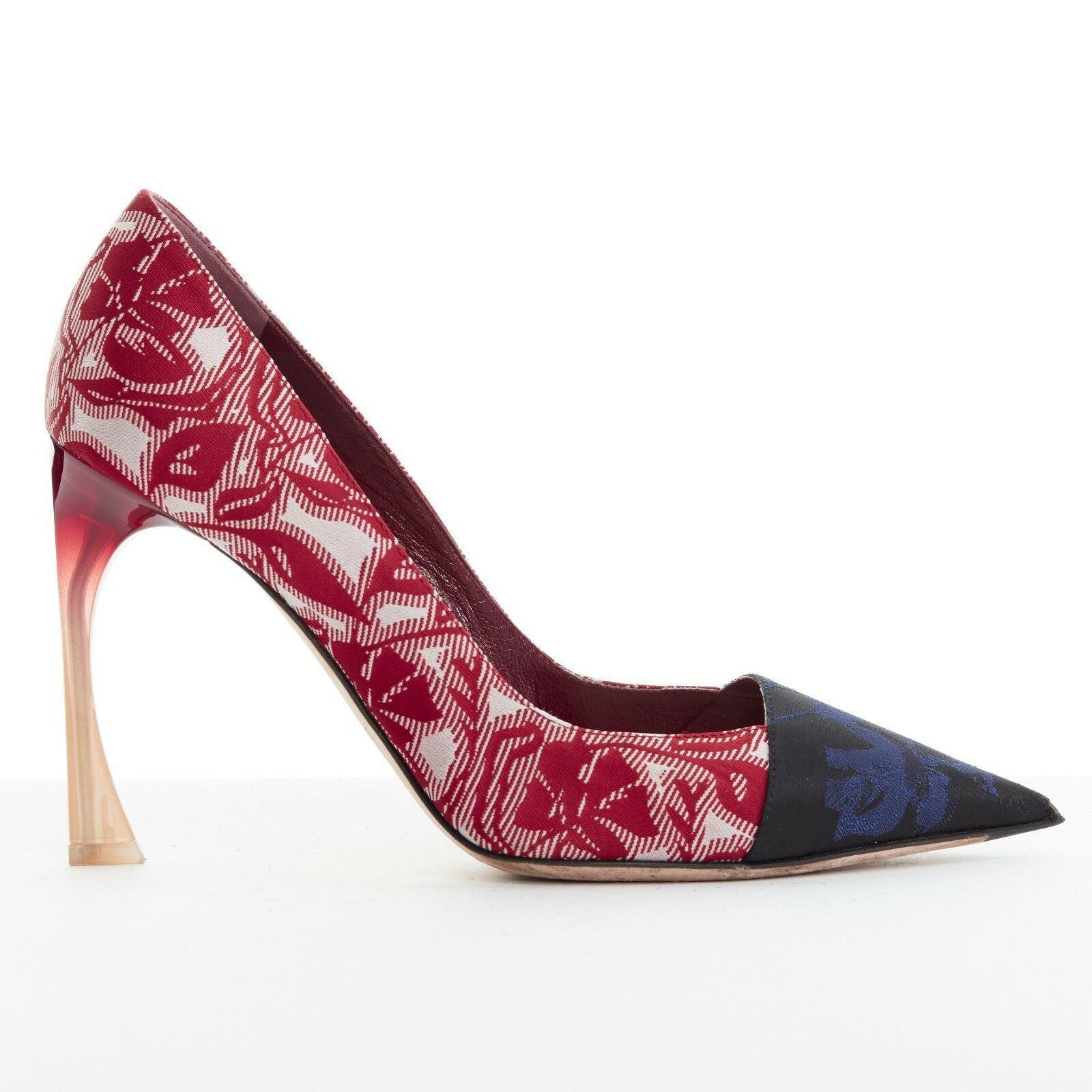 CHRISTIAN DIOR RAF SIMONS red blue floral brocade curved lucite heel pump EU36.5
CHRISTIAN DIOR BY RAF SIMONS
Red and white floral brocade covered. Blue and black brocade covered toe. 
Pointed toe. Covered heel. Red to beige lucite curved heel.