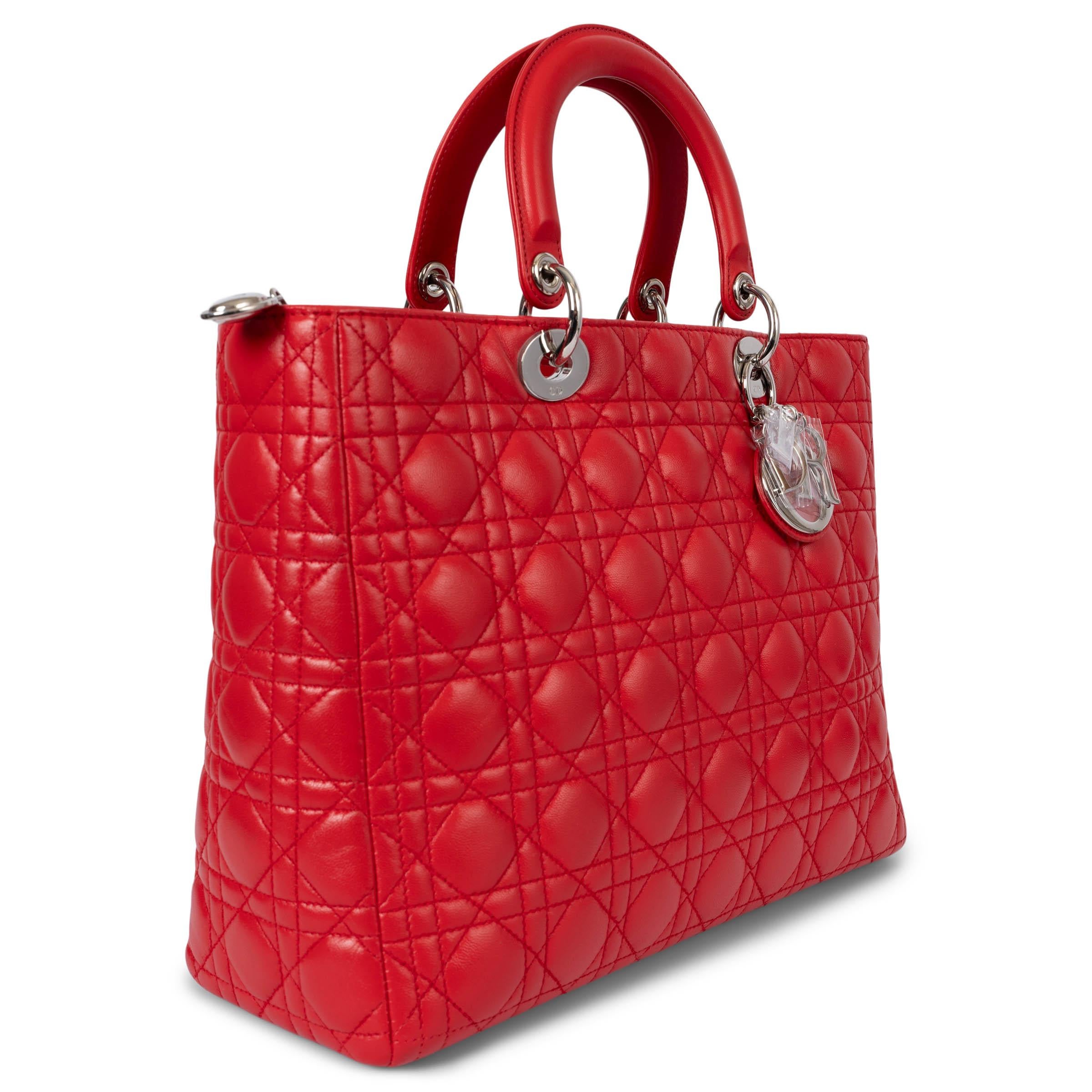 100% authentic Christian Dior Large Lady Dior shoulder bag in red cannage lambskin featuring silver-tone hardware. Opens with a zipper on top and is lined in red classic Dior Oblique nylon with one zipper pocket against the back. Comes with a