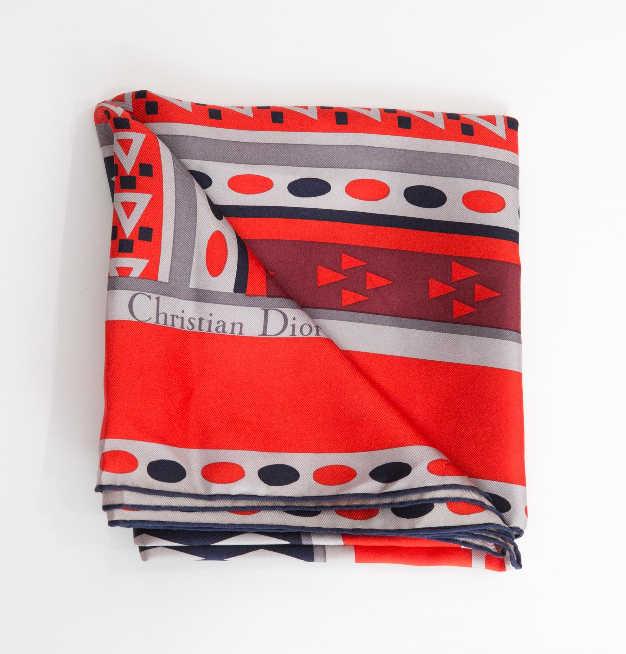Christian Dior Red Silk Scarf featuring a geometric print, and a top logo signature. 
100% silk. Circa 1970s  
In good vintage condition. Made in France.
30.7in (78cm)  X 30.7in (78cm)
We guarantee you will receive this  iconic item as described and