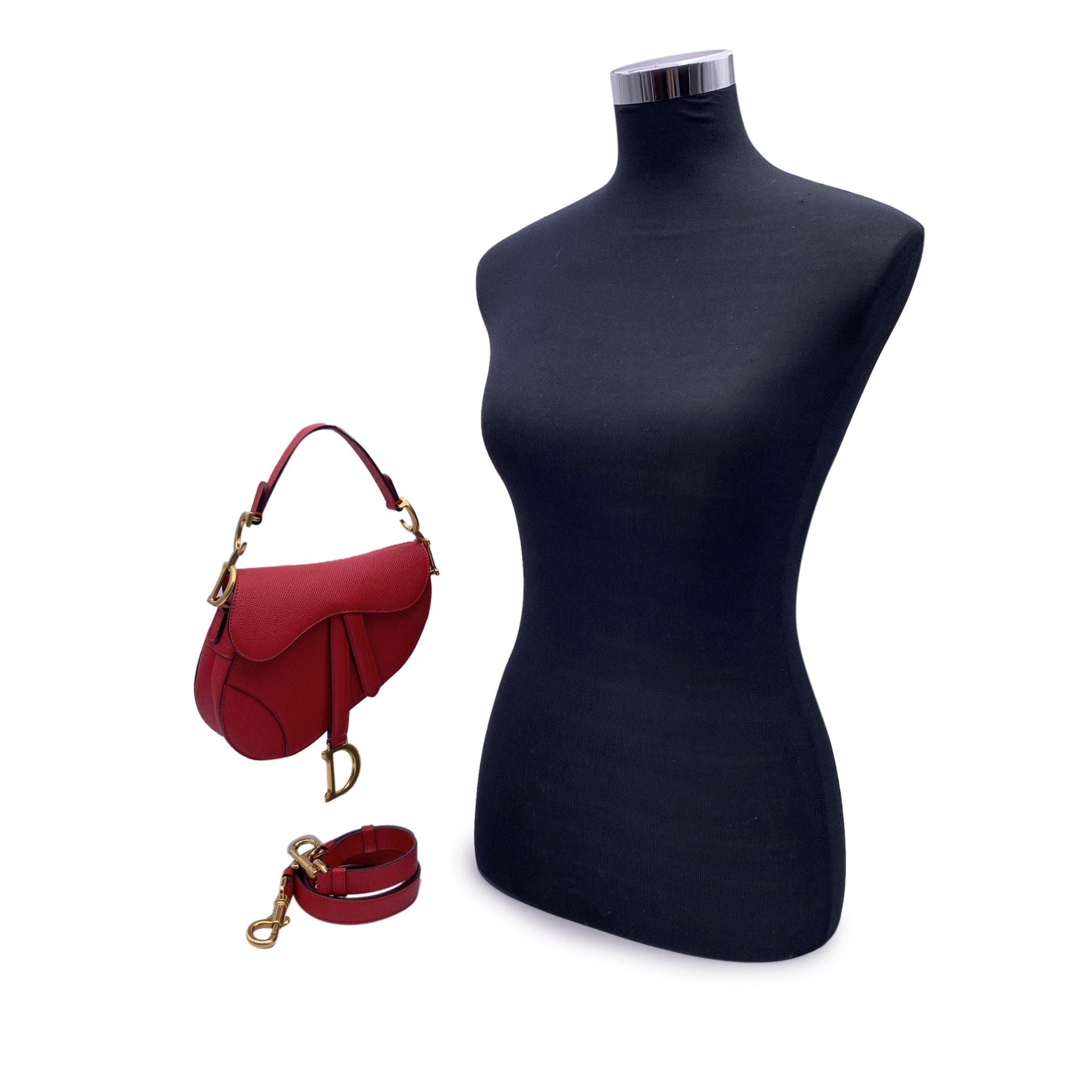 This beautiful Bag will come with a Certificate of Authenticity provided by Entrupy. The certificate will be provided at no further cost. Gorgeous CHRISTIAN DIOR Mini Saddle Bag. This stylish shoulder bag is crafted of red Amaryllis grained