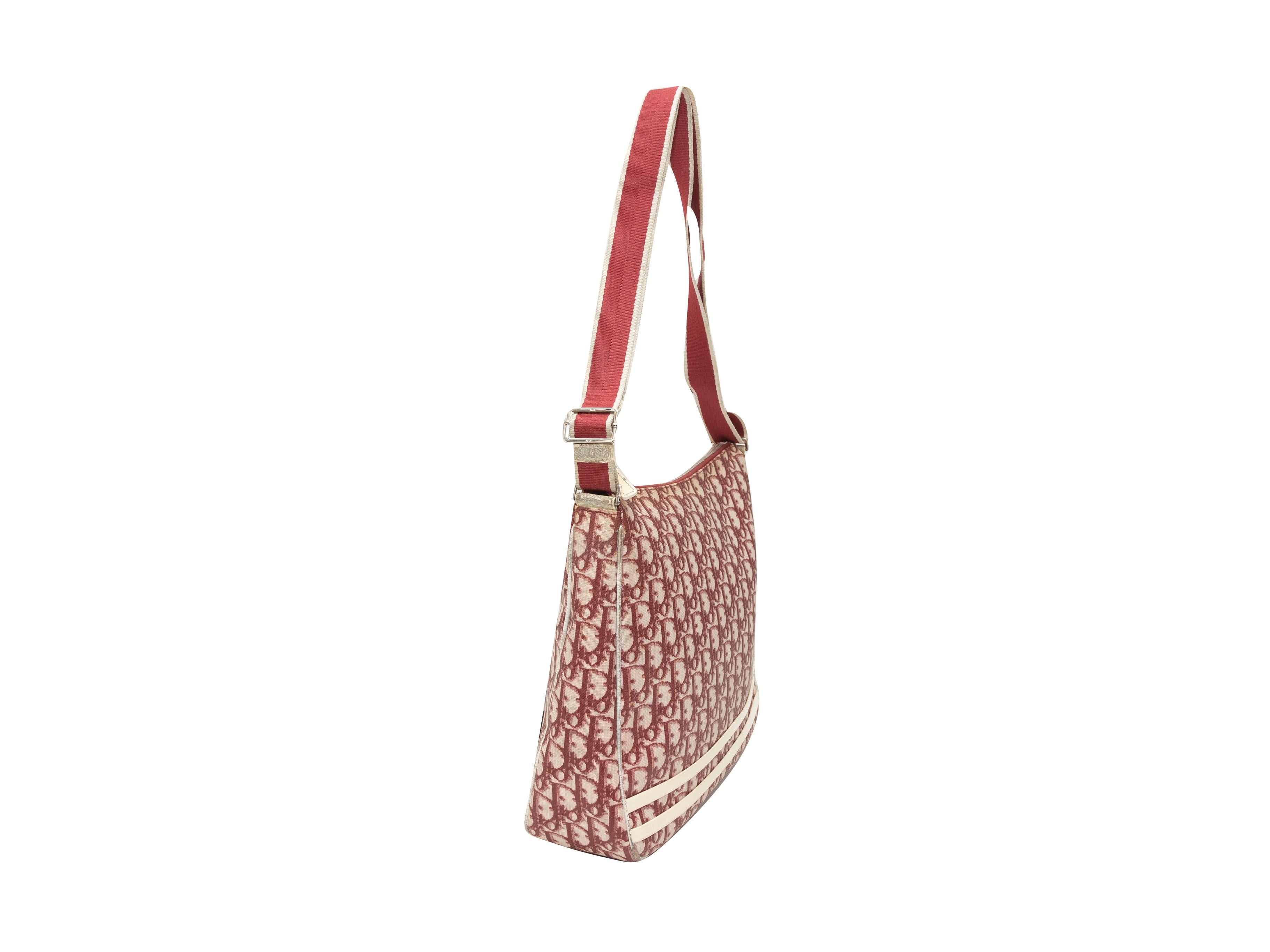 Product details: Vintage red and white Oblique Trotter Messenger Bag by Christian Dior. Circa 2004. Adjustable strap. 12
