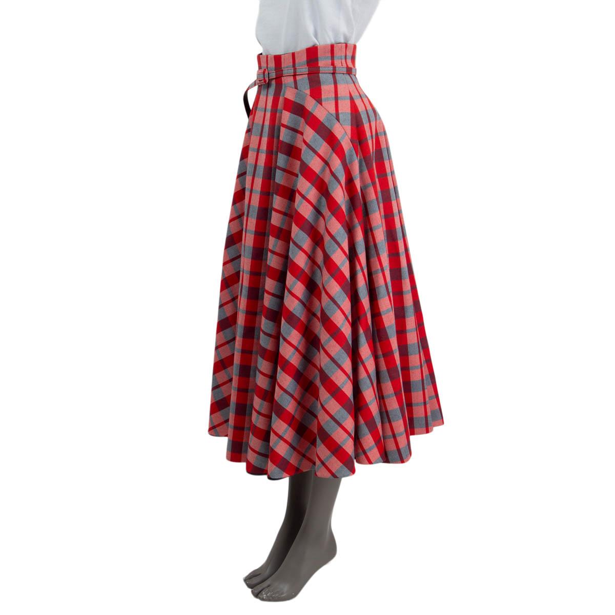 100% authentic Christian Dior Fall/Winter 2021 Check'n'Dior tartan midi skirt in red, navy and off-white virgin wool (100%). Features a detachable matching belt. Opens with a concealed zipper and a hook on the back. Lined in navy silk (100%). Has
