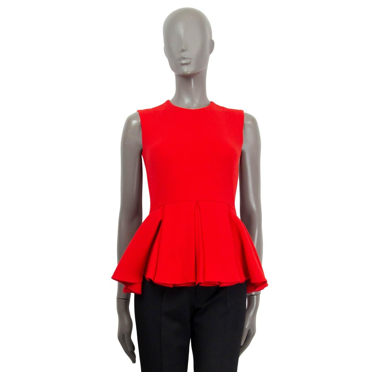 100% authentic Christian Dior sleeveless flared top in red virgin wool (100%). Opens with a zipper and a hook at the back. Lined in red silk (100%). Shows some faint deodorant stains at the inside armpits, otherwise in excellent