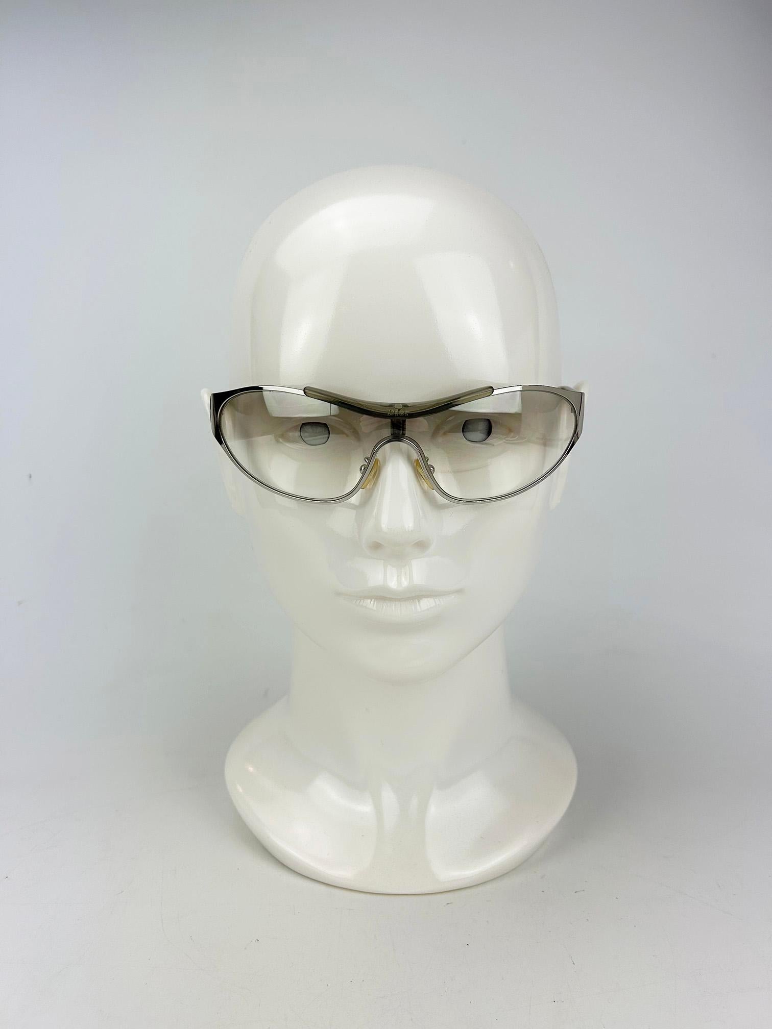 Christian Dior Rider Sunglasses Silver Frame Clear Lens Vintage c2000s in very good condition. Unique and rare vintage sunglasses. Tinted clear gradient lenses trimmed with clear acrylic and silver hardware. Signed Dior made in Italy inside arms.