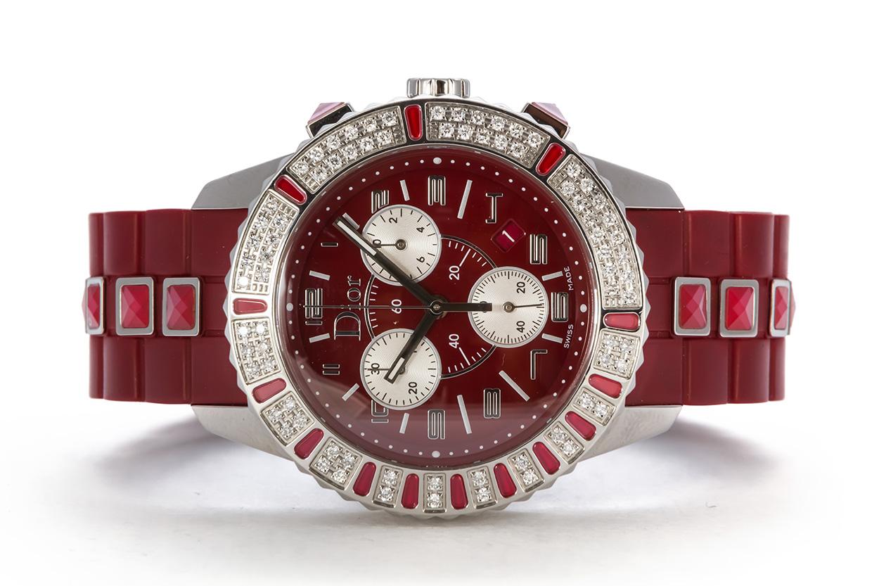 We are pleased to offer this Christian Dior Ruby Red Christal Chronograph Quartz Watch CD11431BR001. This watch features a chronograph quartz movement, sapphire crystal, red dial and rubber strap, white diamonds and red sapphire crystals set in a